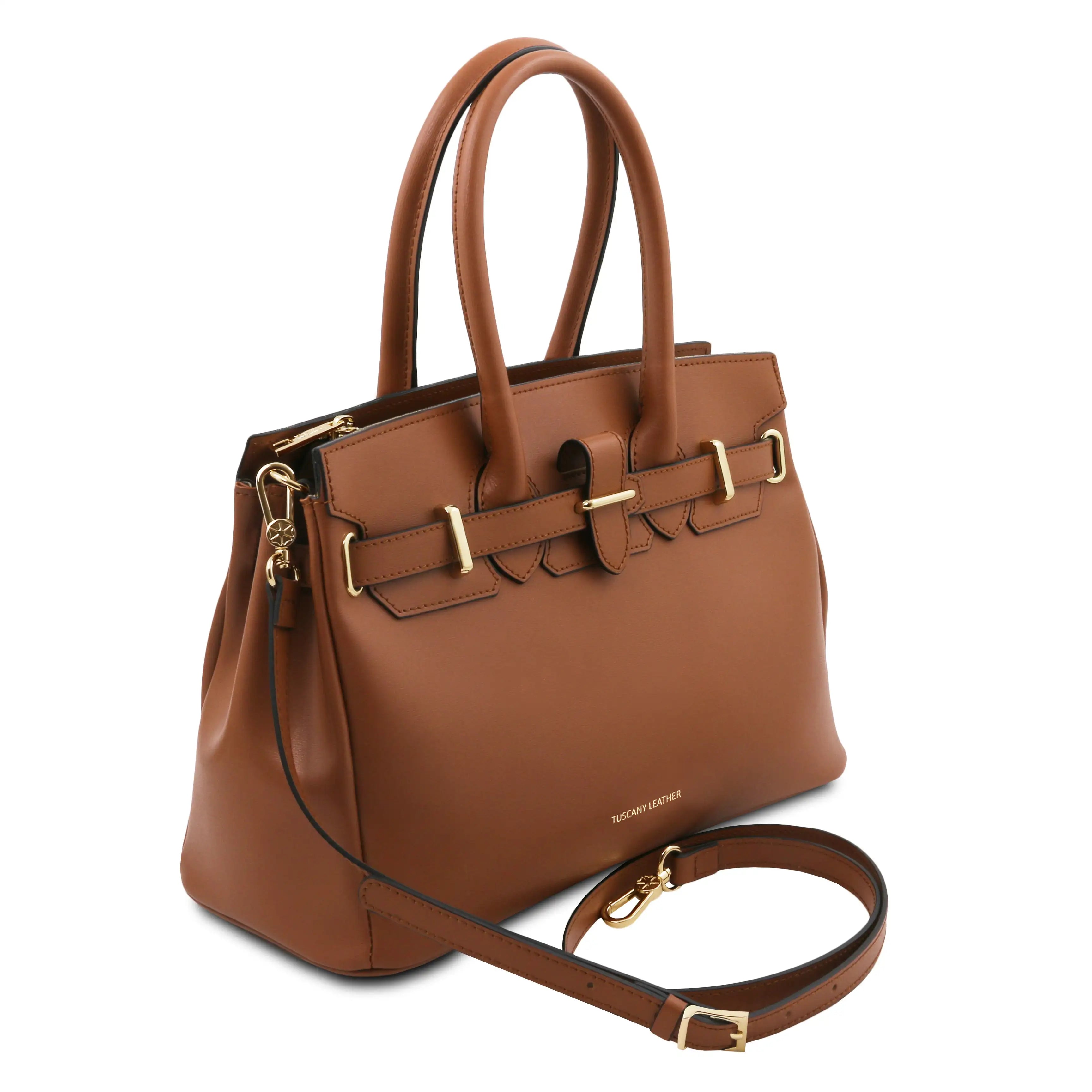 Brown leather handbag with gold accents on a white background