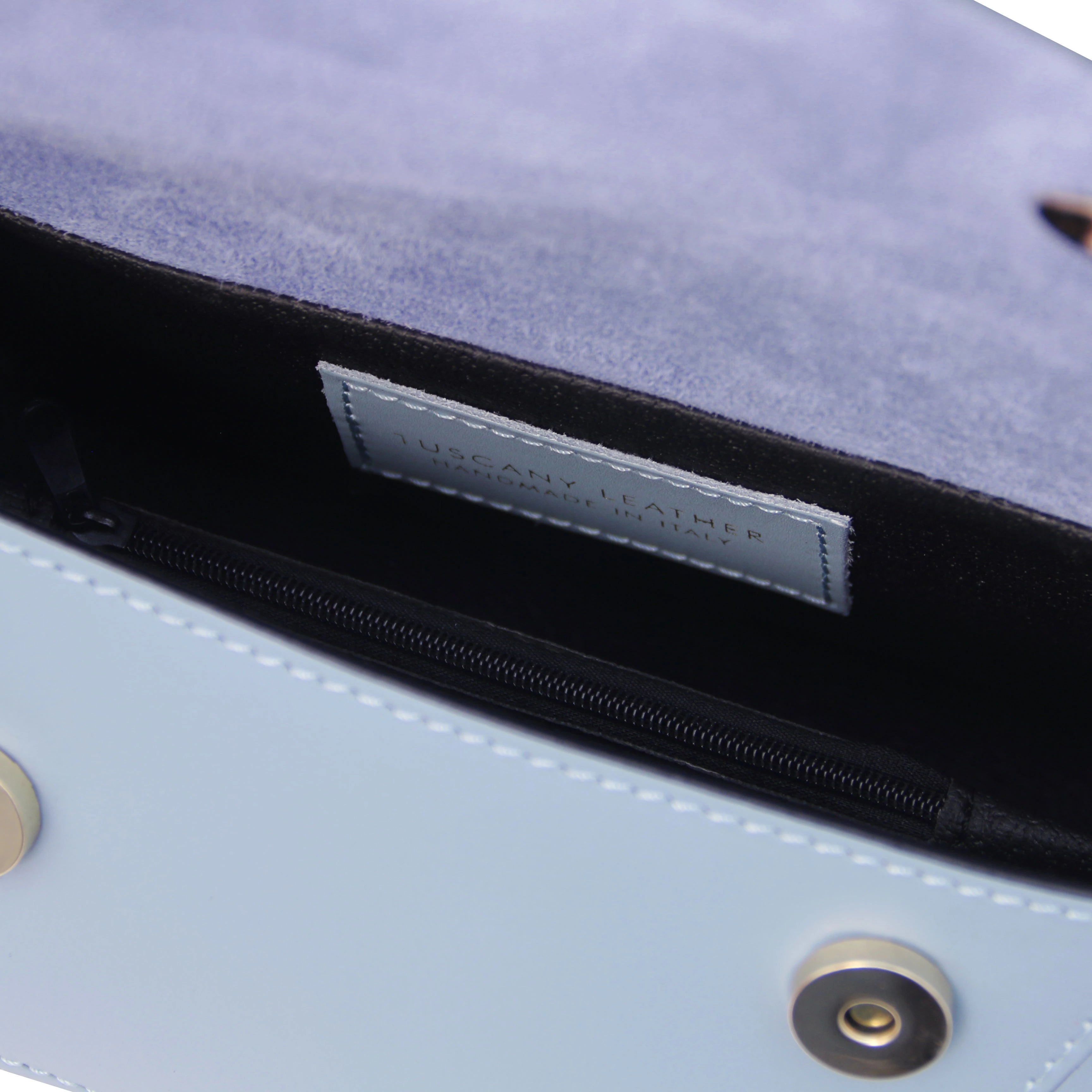 Interior view TL Leather Assymetrical Shoulder Bag in Azure blue showing Tuscany Leather branding and magnetic button closures