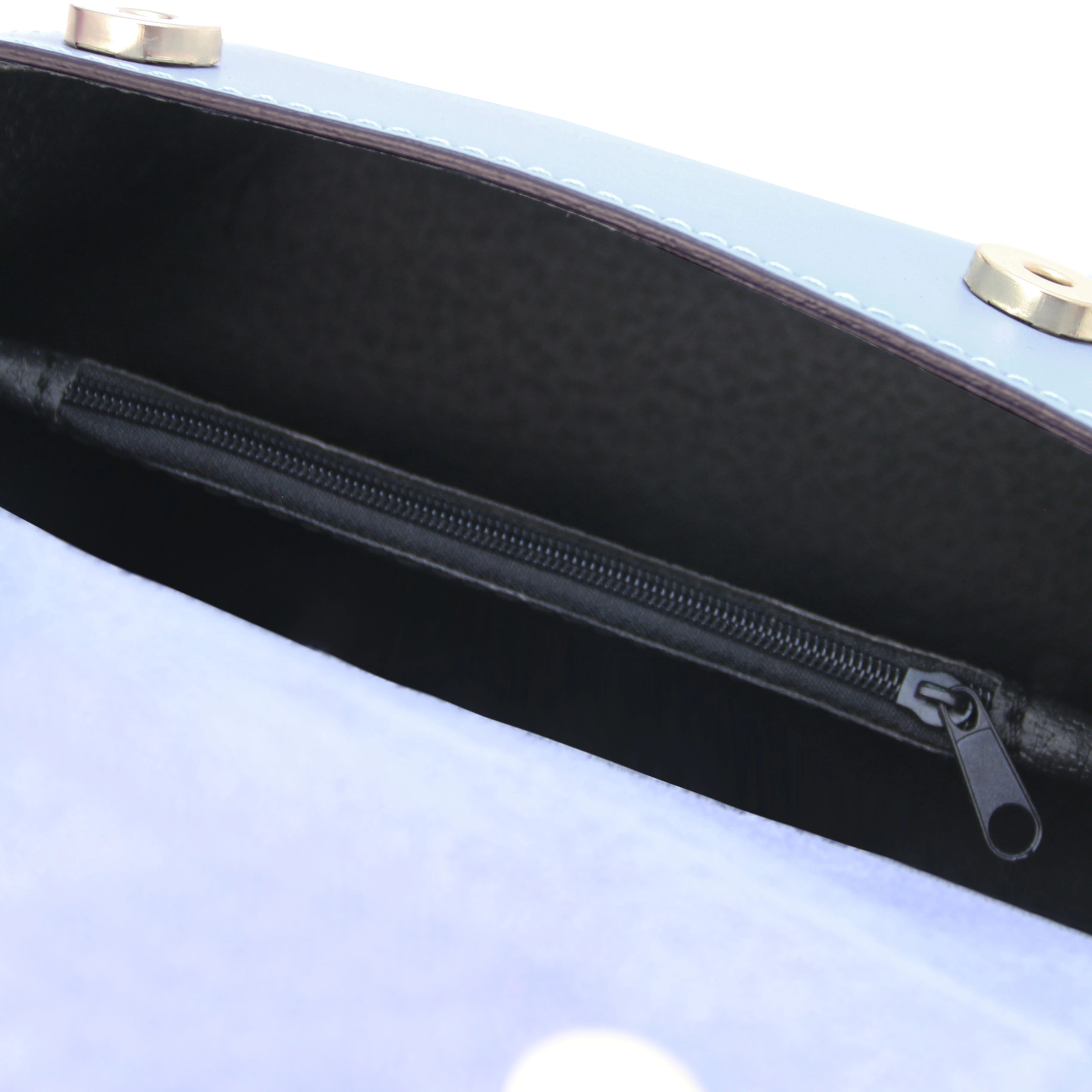 Interior zip pocket view TL Leather Assymetrical Shoulder Bag in Blue showing magnetic button closures