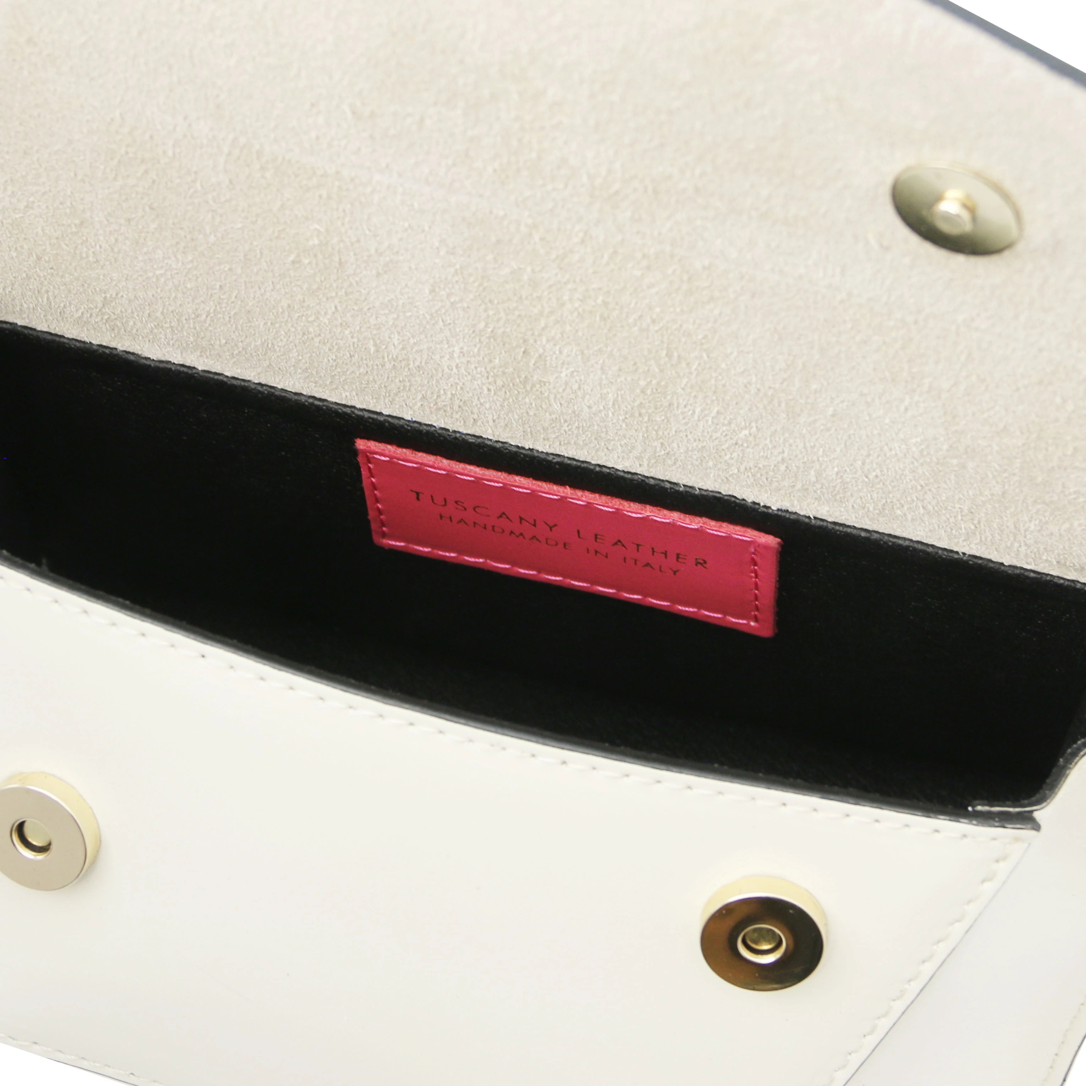 Interior view TL Leather Assymetrical Shoulder Bag in Beige showing Tuscany Leather branding and magnetic button closures