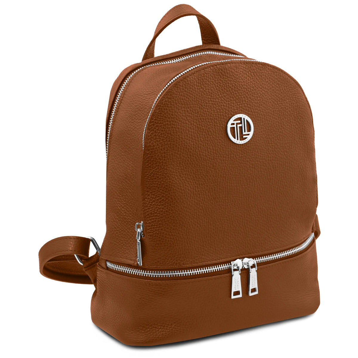 A cognac pebbled leather backpack with silver-tone hardware, featuring a top handle, a lower zippered compartment, and a circular metallic logo emblem on the front.