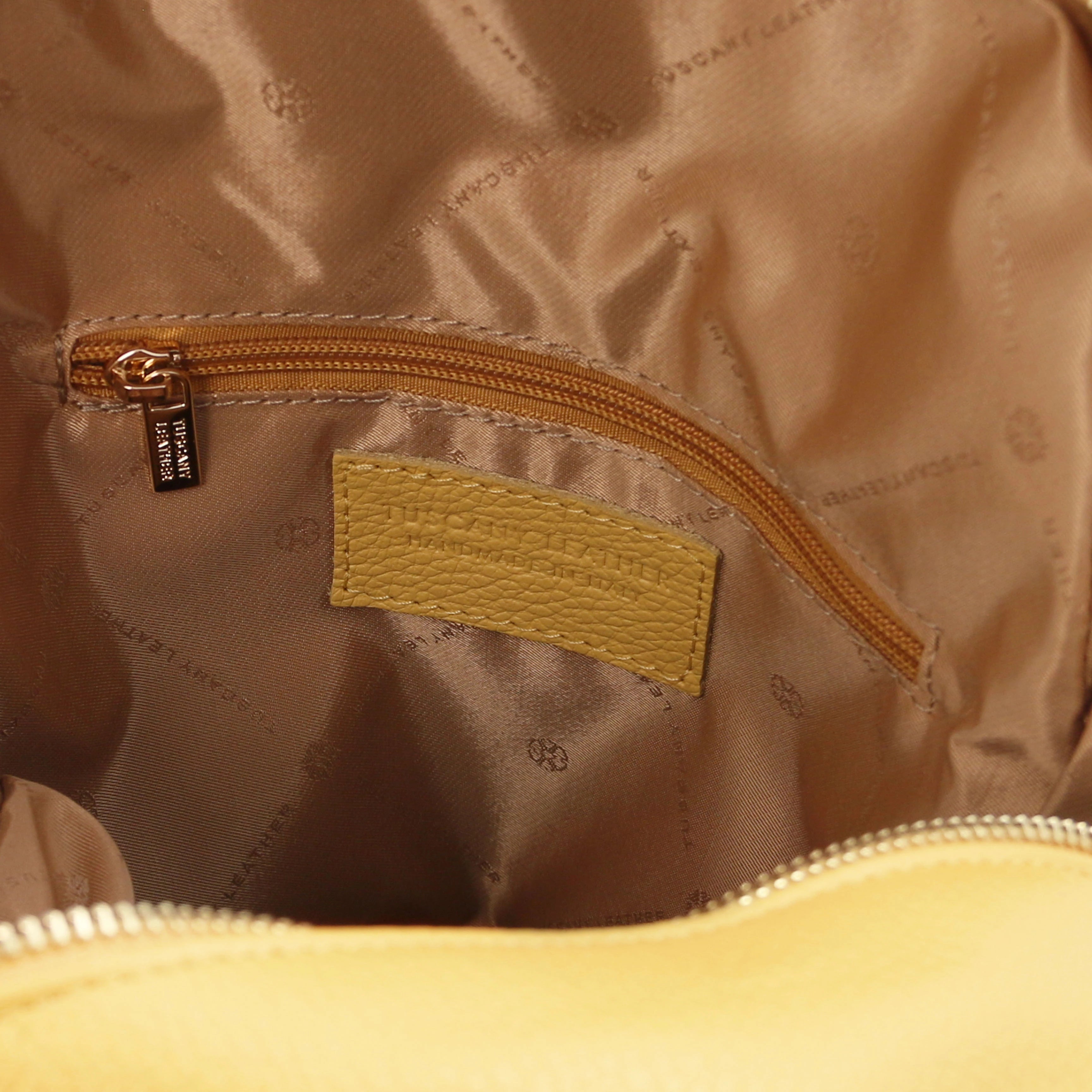 Interior zip pocket view TL Bag Italian Soft Leather Zip Backpack in pale yellow showing tan lining