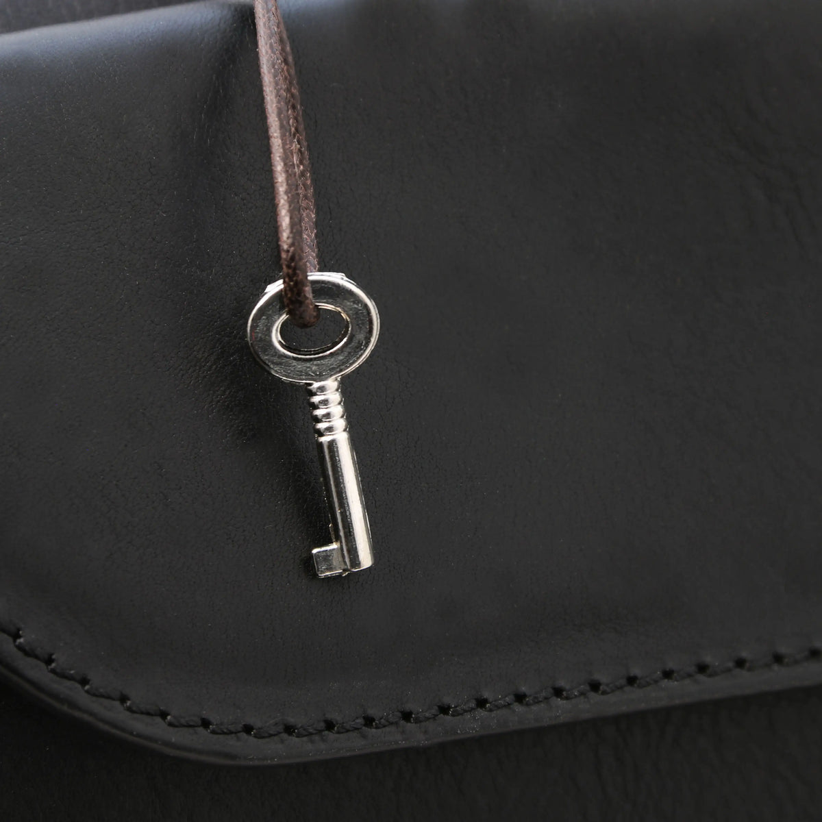 Black leather doctor bag with a key gold lock closure