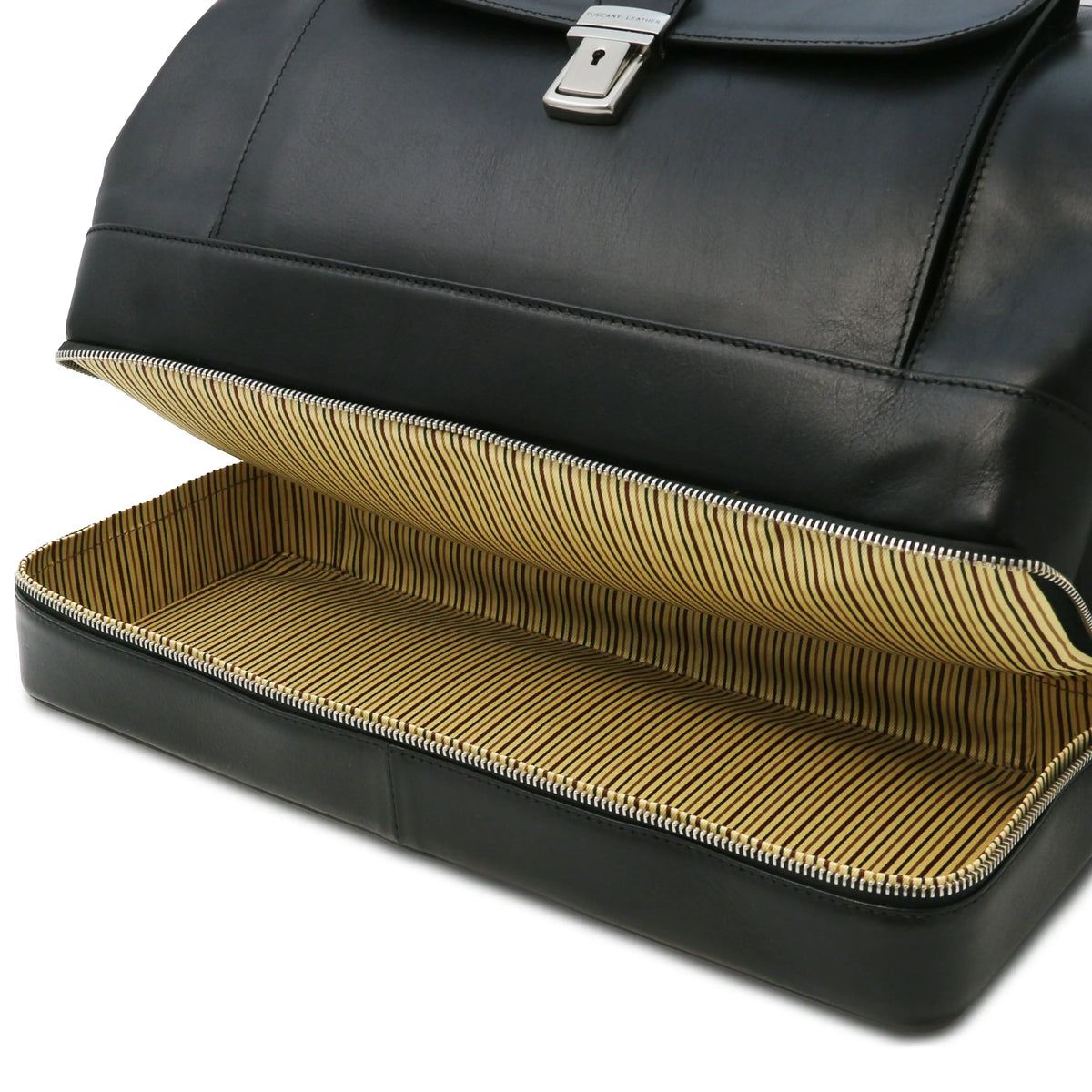 Bottom zip compartment view of black leather doctor bag with gold interior striped lining on a white background