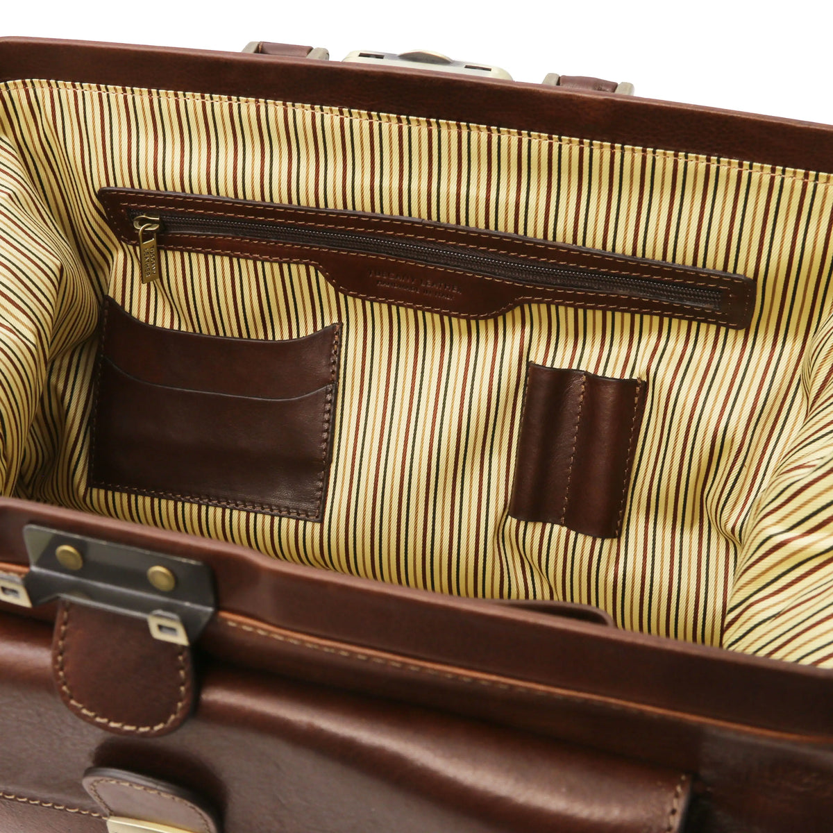 Close-up of a dark brown leather doctor bag with zipped pocket, card and pen slots and striped interior.