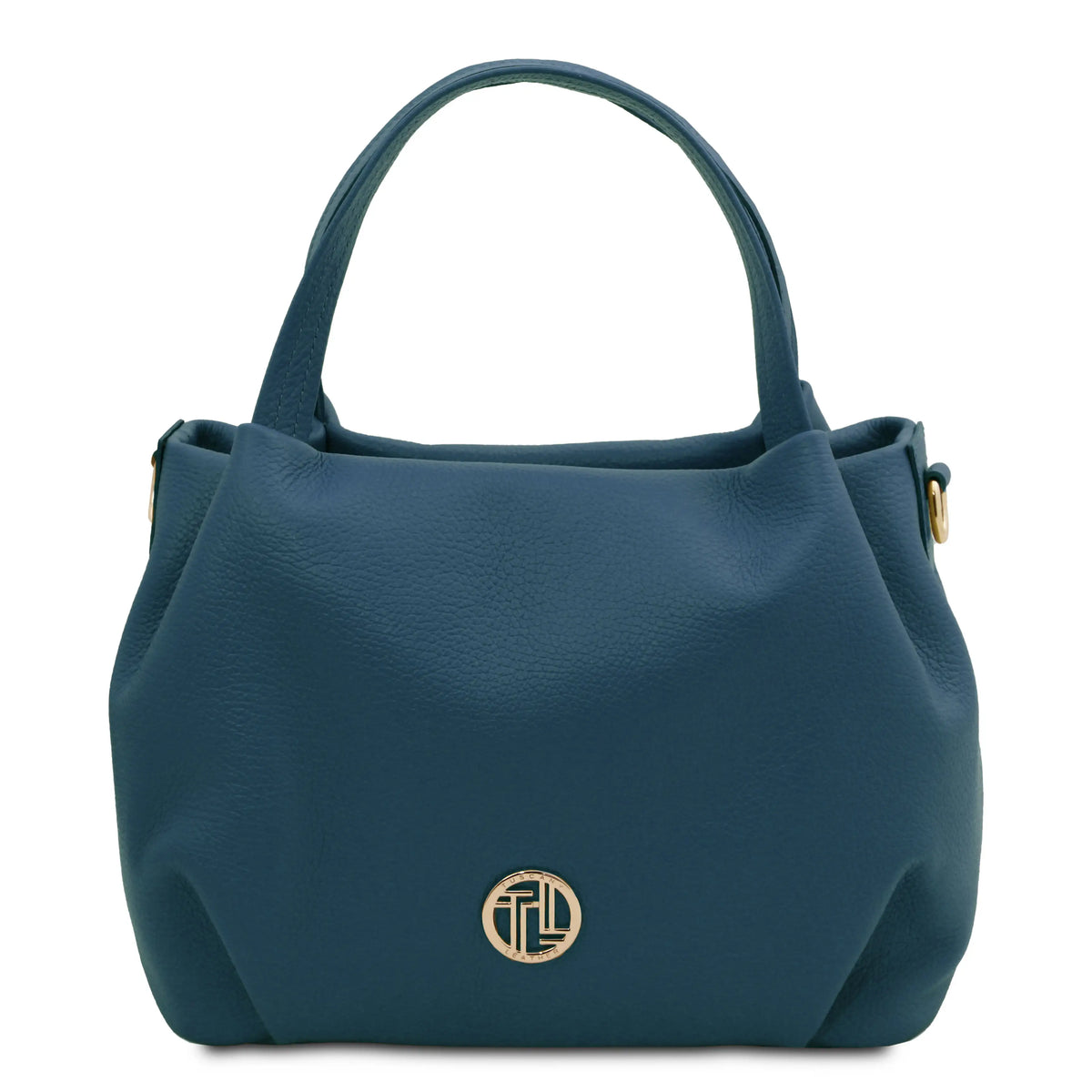 A dark teal pebbled leather handbag with dual top handles and a gold-tone circular monogram logo on the front, set against a plain white background.