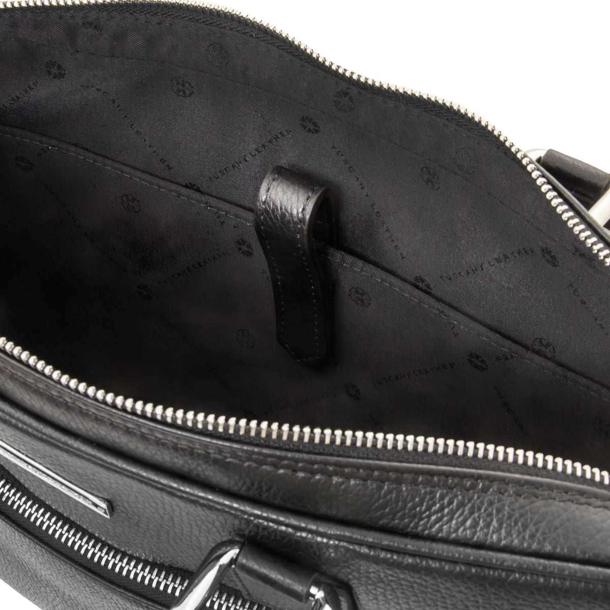 Close-up of a black leather bag with a zipper, showing the black interior and laptop compartment