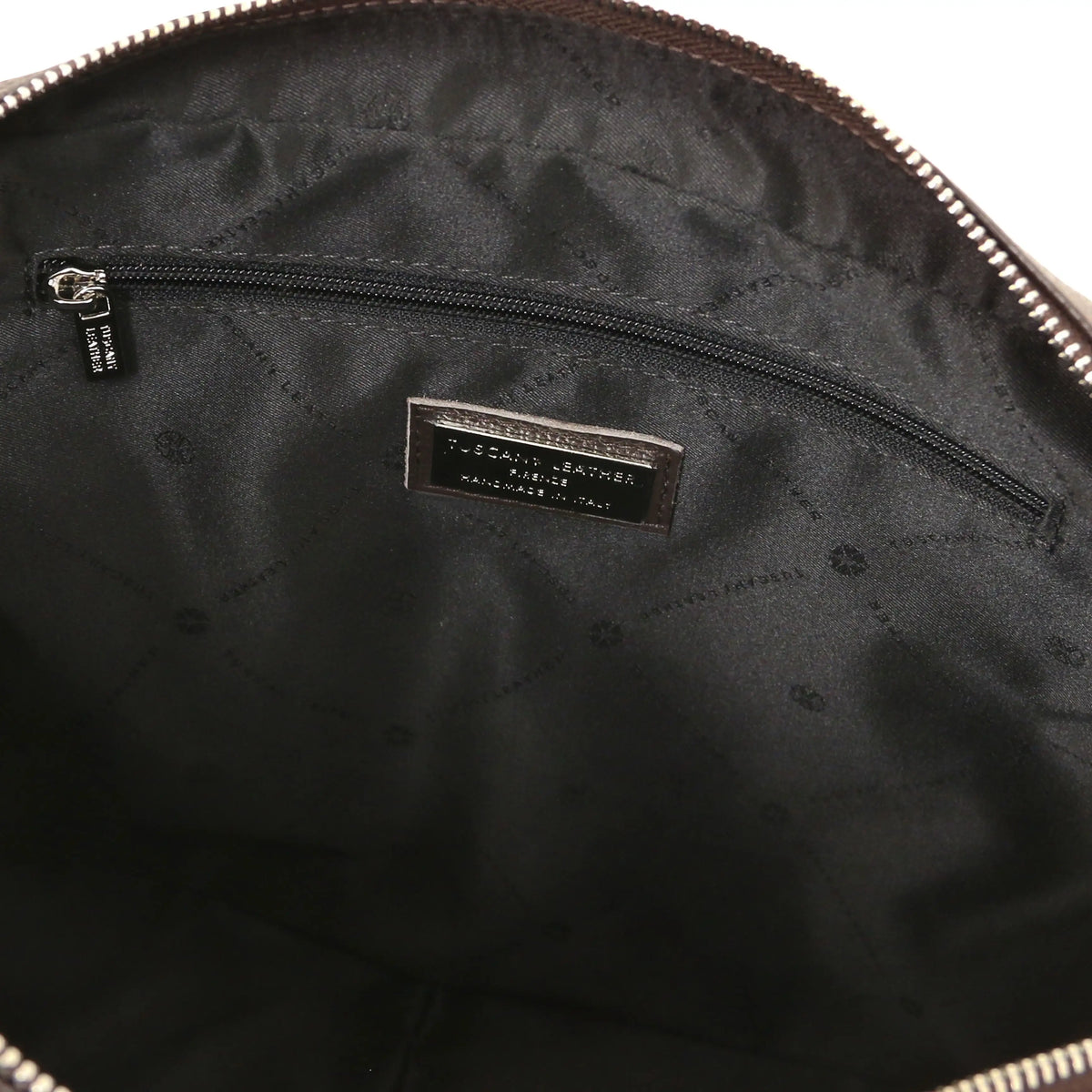 Close-up of a dark brown leather bag with a zipper, showing the black interior and zip pocket