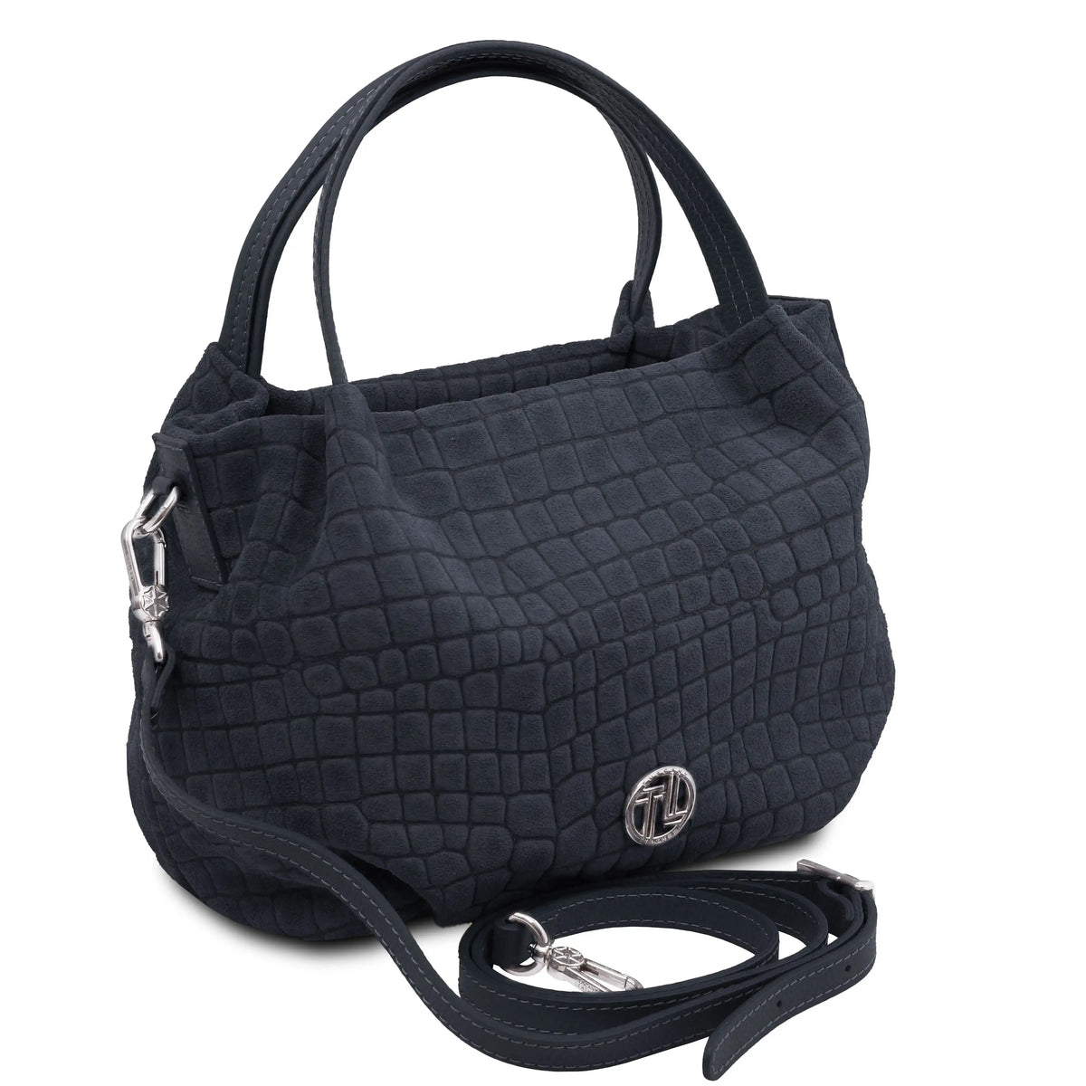 A dark blue textured handbag with a crocodile-embossed pattern, featuring dual top handles, a detachable shoulder strap, and a silver-tone logo emblem on the front.