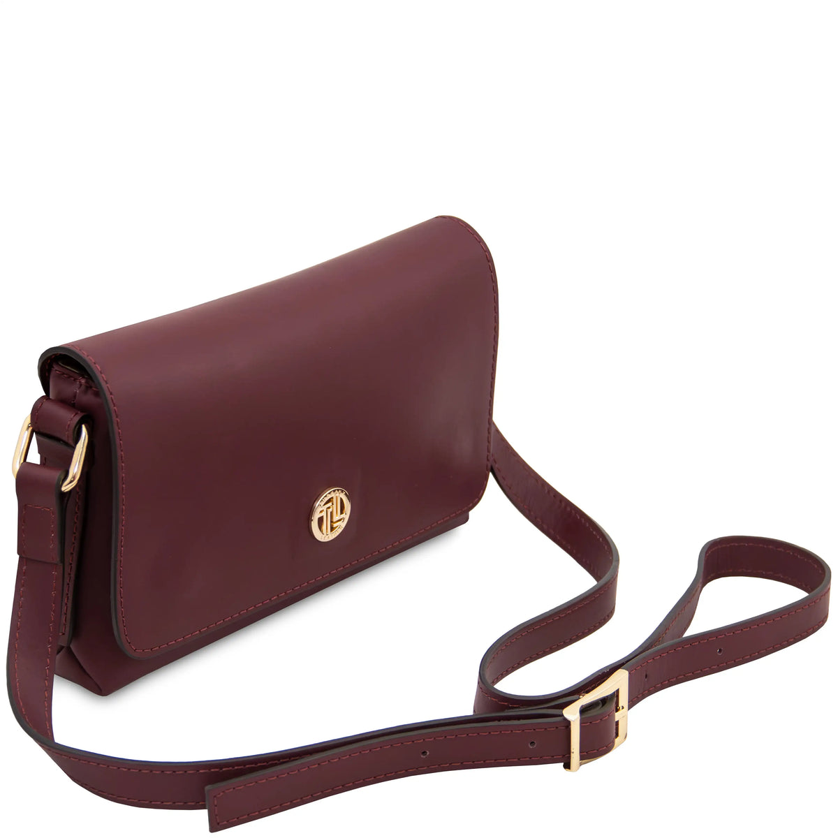 A burgundy leather crossbody bag with a gold-tone logo emblem and adjustable strap, displayed on a clean white background.