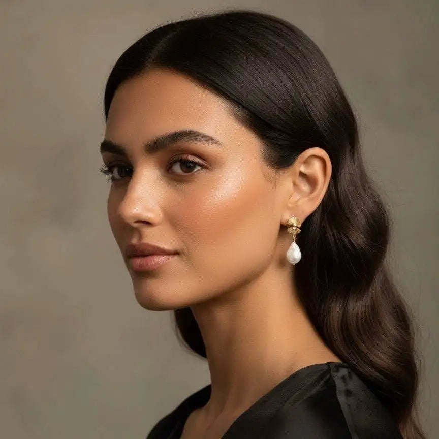 Solia Stud Pearl Earrings on a female model with dark brown hair wearing a black top.