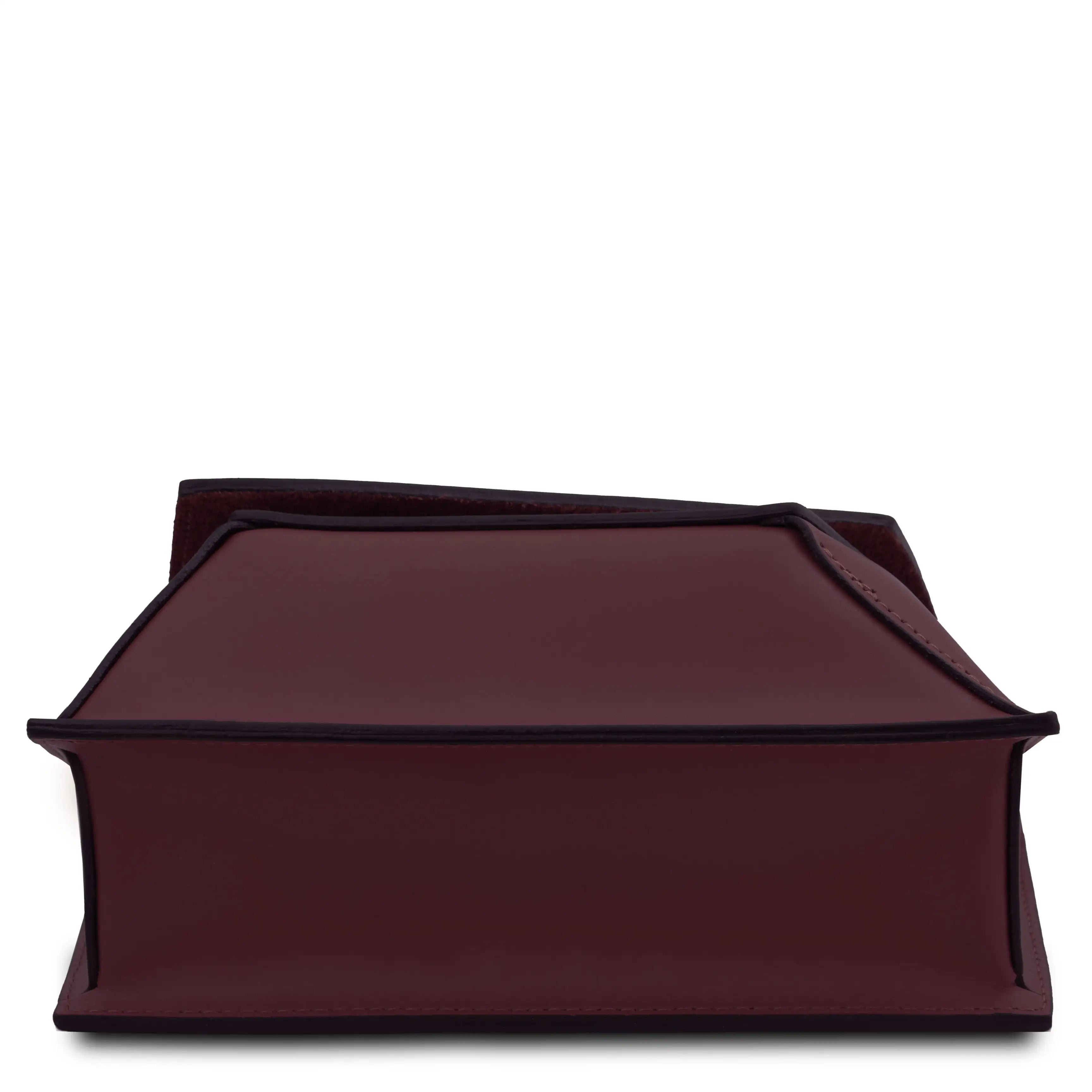 Bottom view bordeaux bag with raw edges on a white background