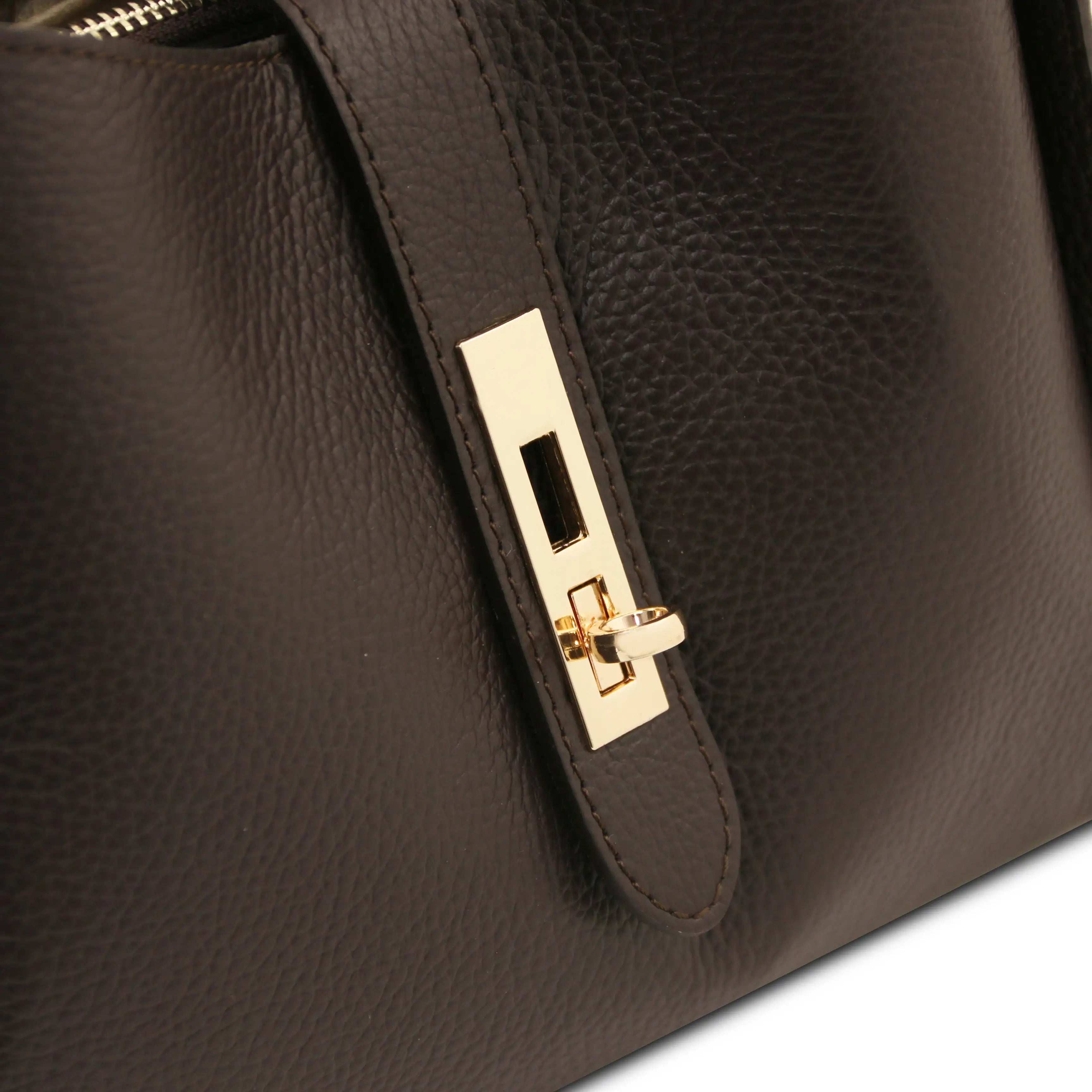 Close-up of a dark brown pebbled leather handbag featuring a gold-tone metal turn-lock closure on a strap.