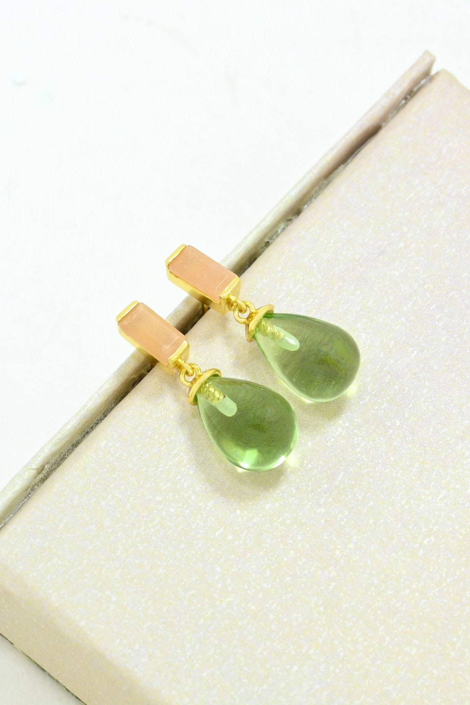 Gracelyn Drop Peach Moonstone & Green Quartz Earrings with gold accents on a box