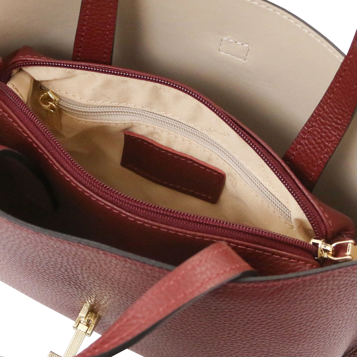 Interior beige lining view Agatha Leather Handbag in bordeaux showing unzipped central compartment