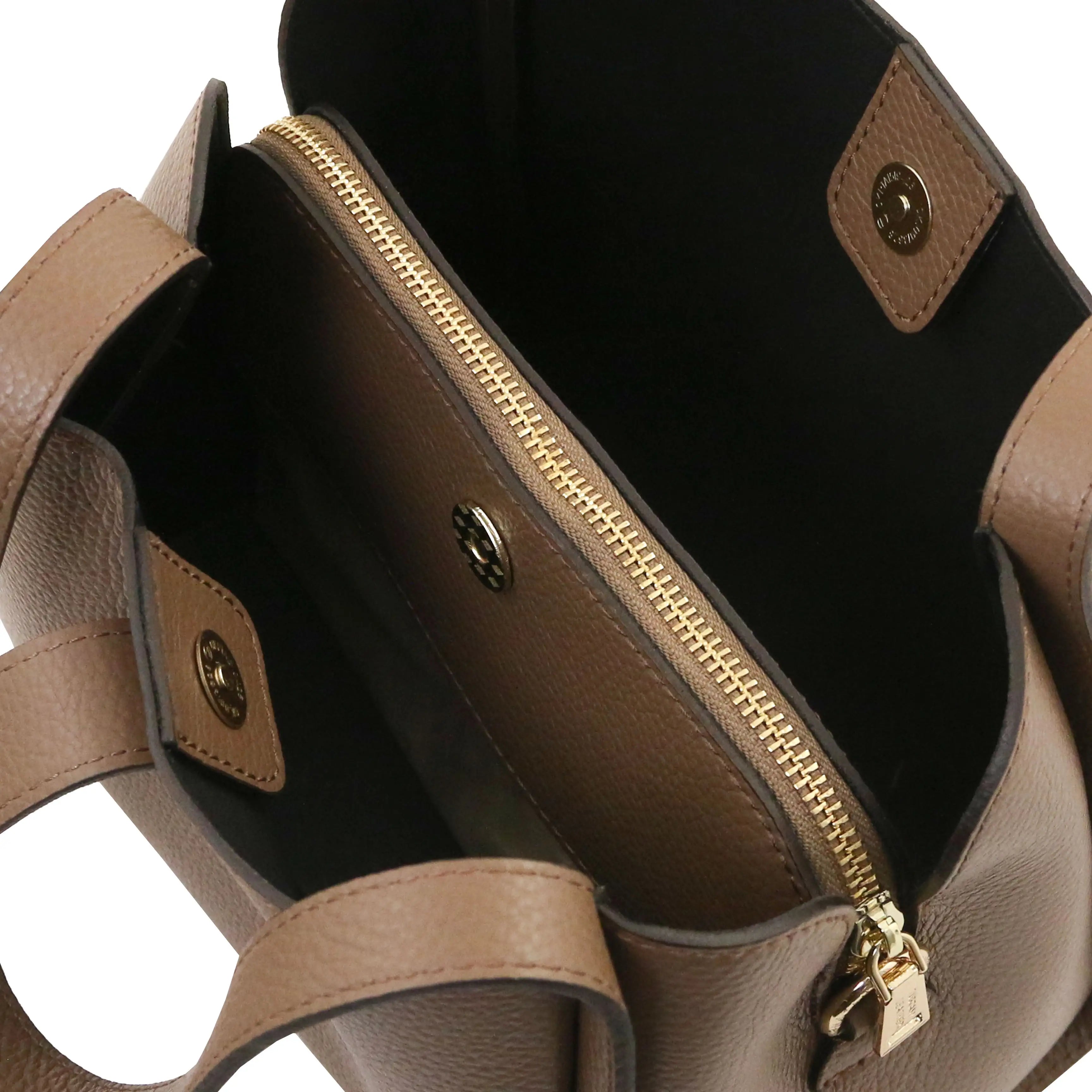 Close-up of the interior of a taupe leather handbag, showing a gold-tone zipper, black lining, and matching leather tab details.