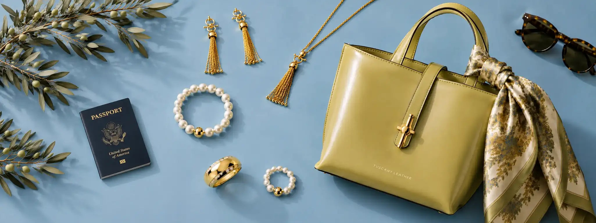 Green handbag with accessories on a blue background