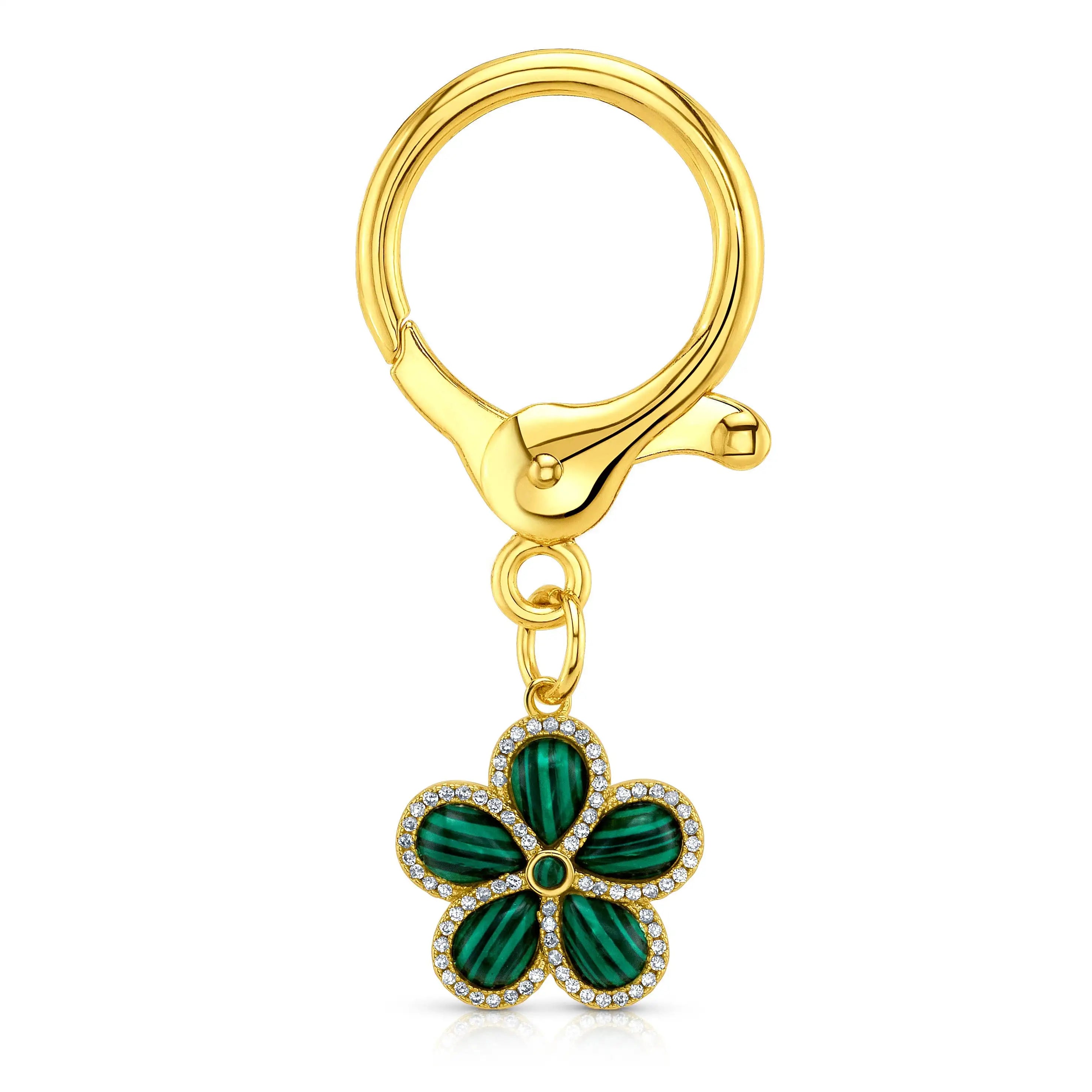 A gold-tone keychain or bag charm featuring a five-petal flower pendant with malchite inlay and a border of small clear rhinestones, attached to a gold clasp on a white background.