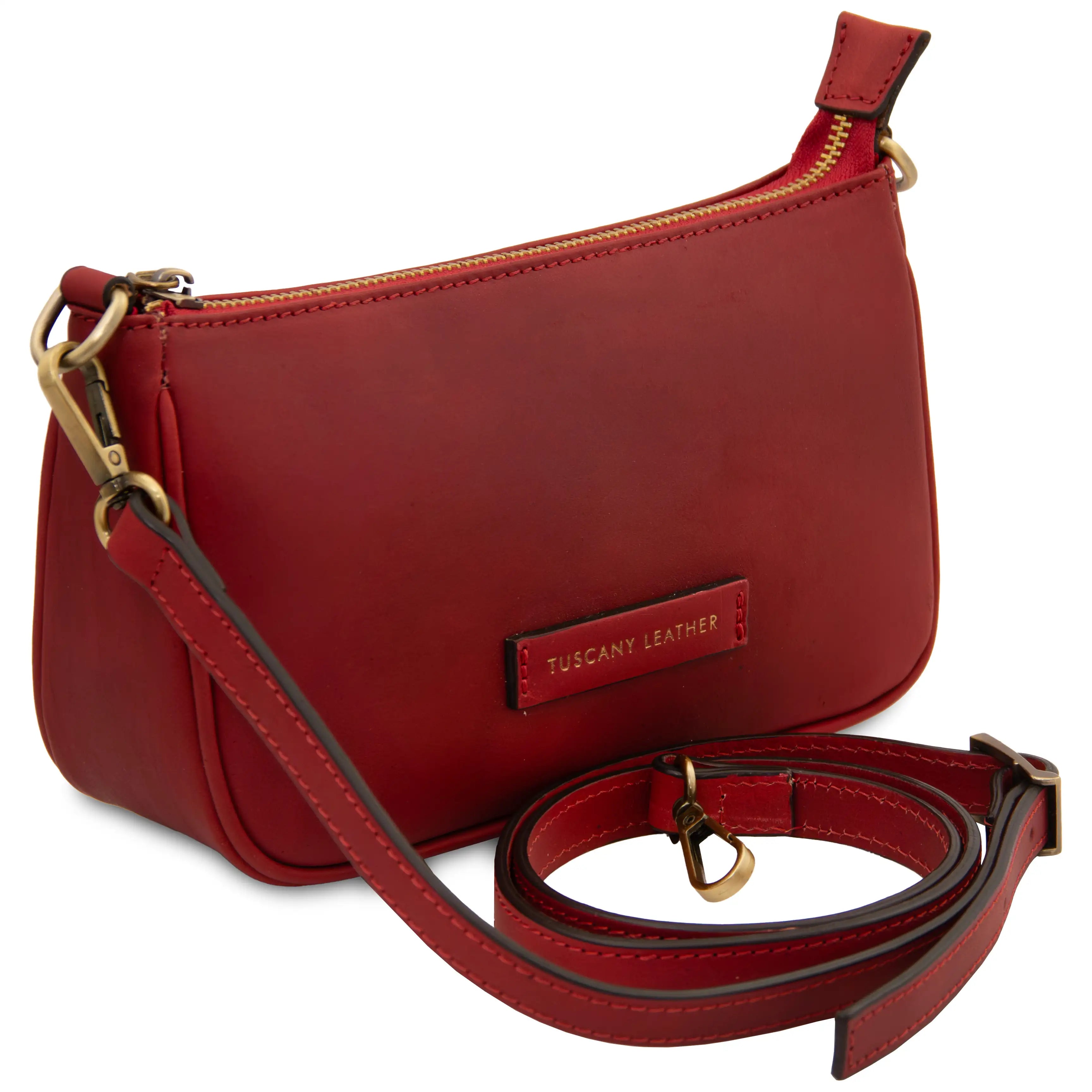 Red leather handbag with a detachable strap on a white background