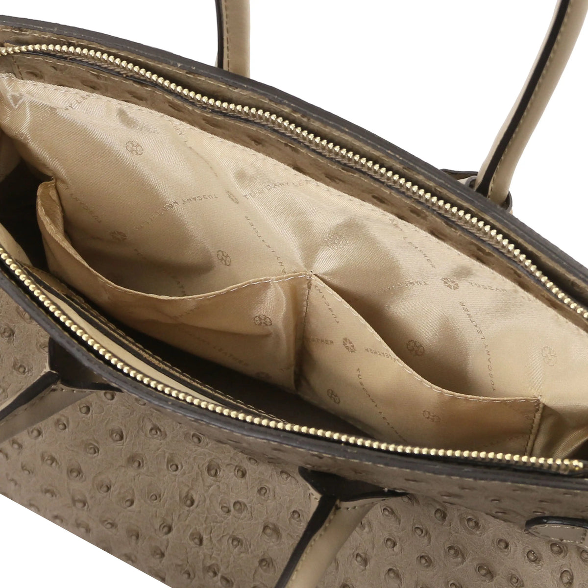 Taupe leather ostrich print handbag with interior open pockets and beige lining on a white background