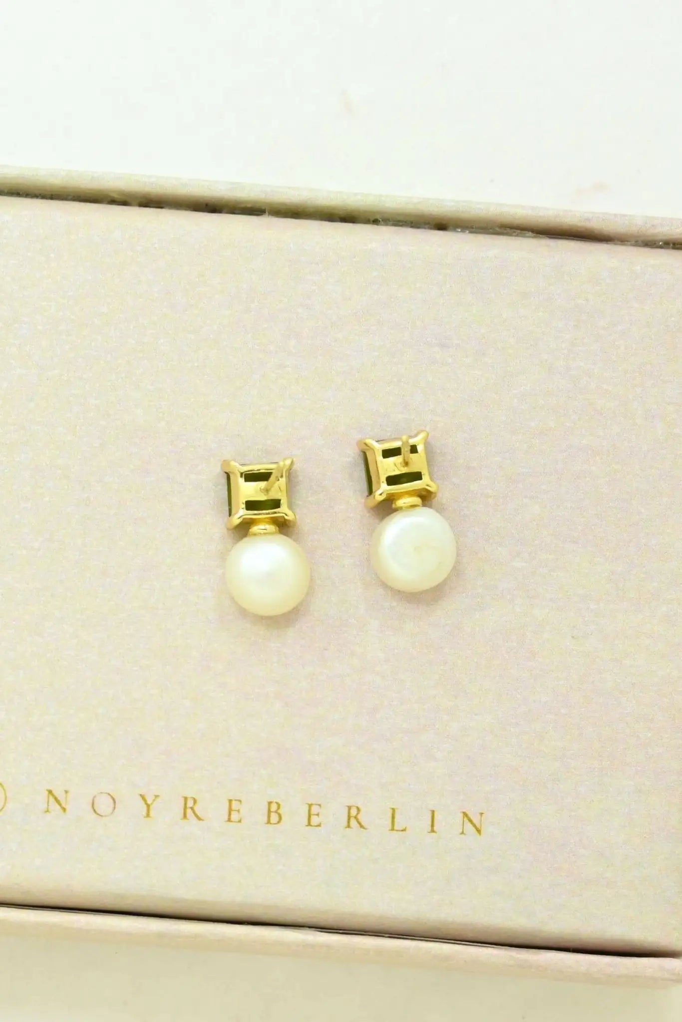 Aaliyah Stud Earrings Pearl & Green Tourmaline laying upside down showing the posts