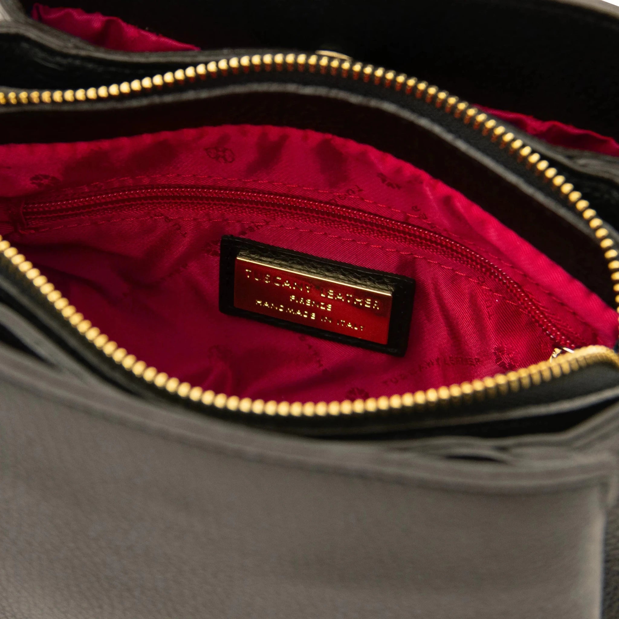 Interior zip pocket view Black Abby Leather Bag with red lining