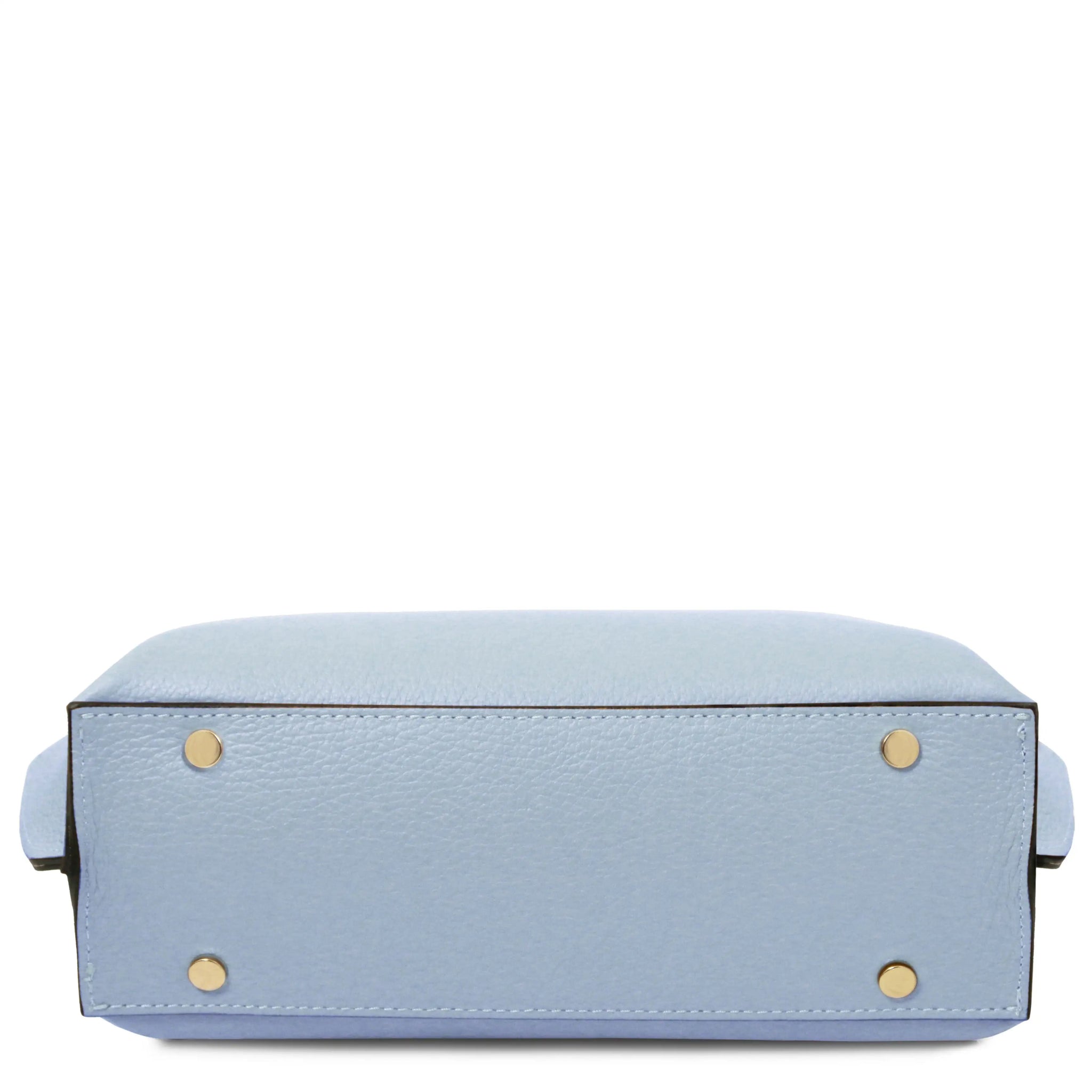 Bottom view Light blue handbag with gold metal protective feet on a white background