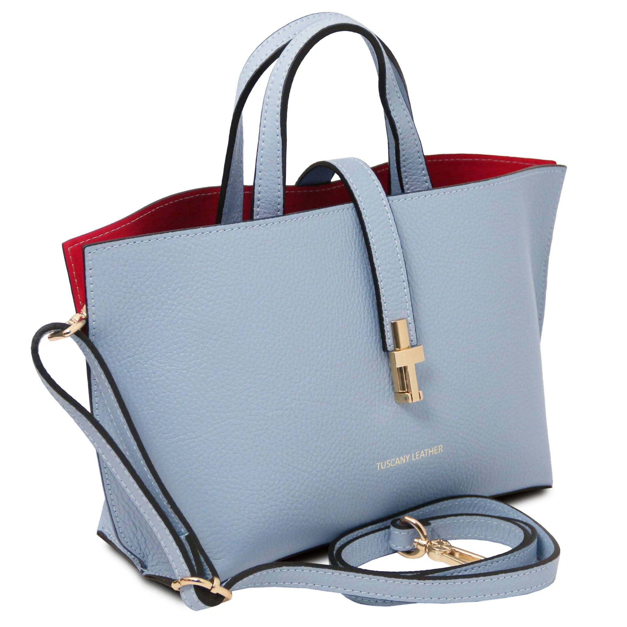 Light blue handbag with gold hardware, red interior and a detachable shoulder strap on a white background.