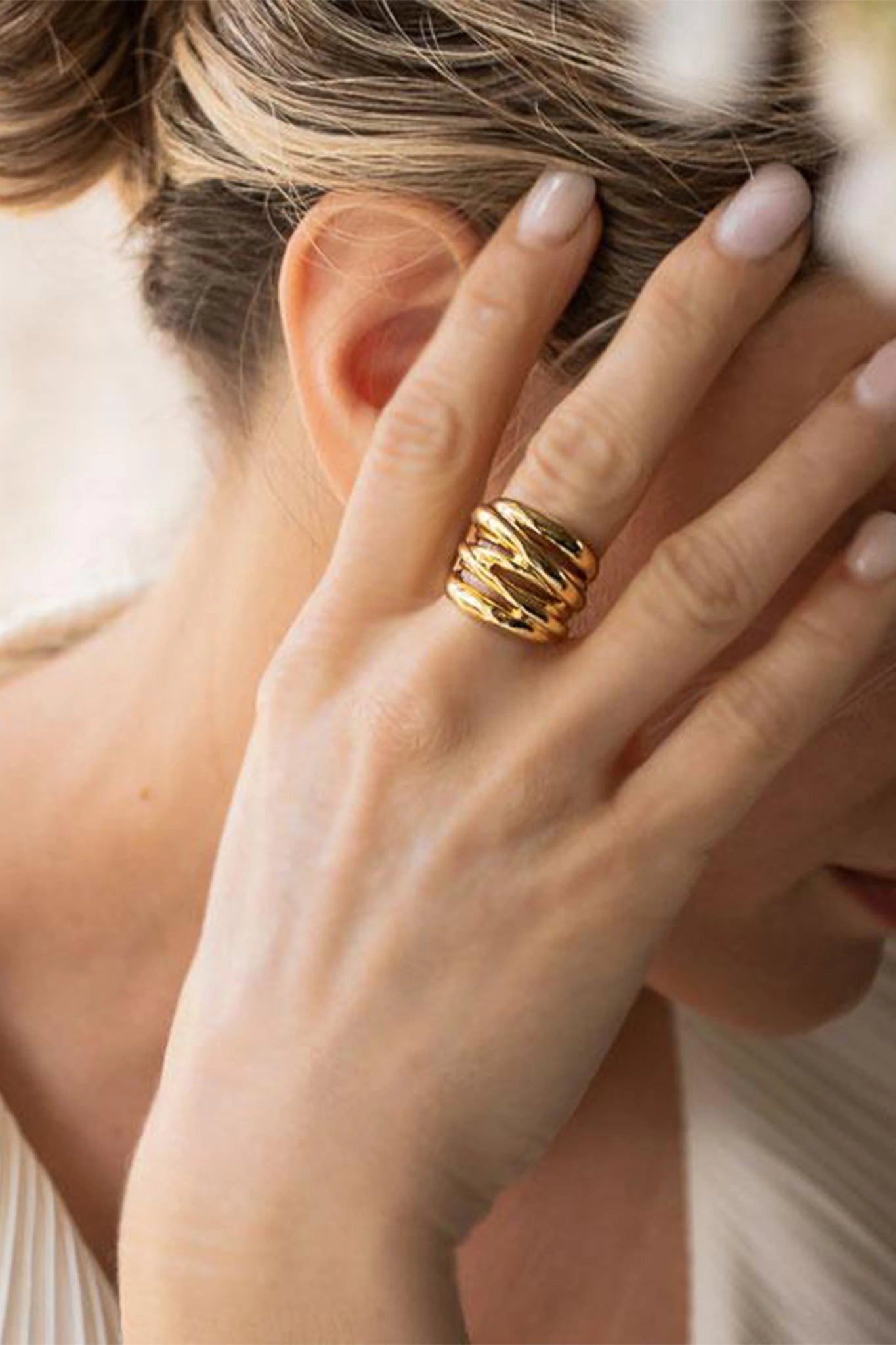 Arezzo Serenity Ring in gold on a female model's right hand- L'Atelier Global