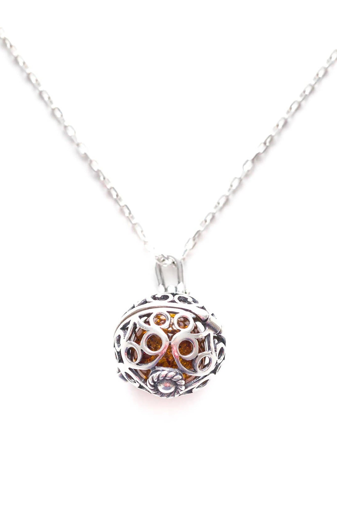 Baltic Honey Amber Sterling Silver Filigree Locket Necklace pendant is closed in front of a white background