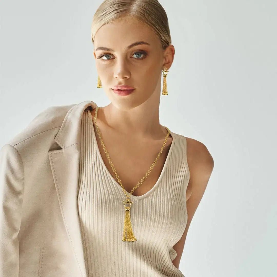 Chantilly Horse Bit Tassel Gold Necklace and Earrings on Model wearing a beige tank top and suit jacket