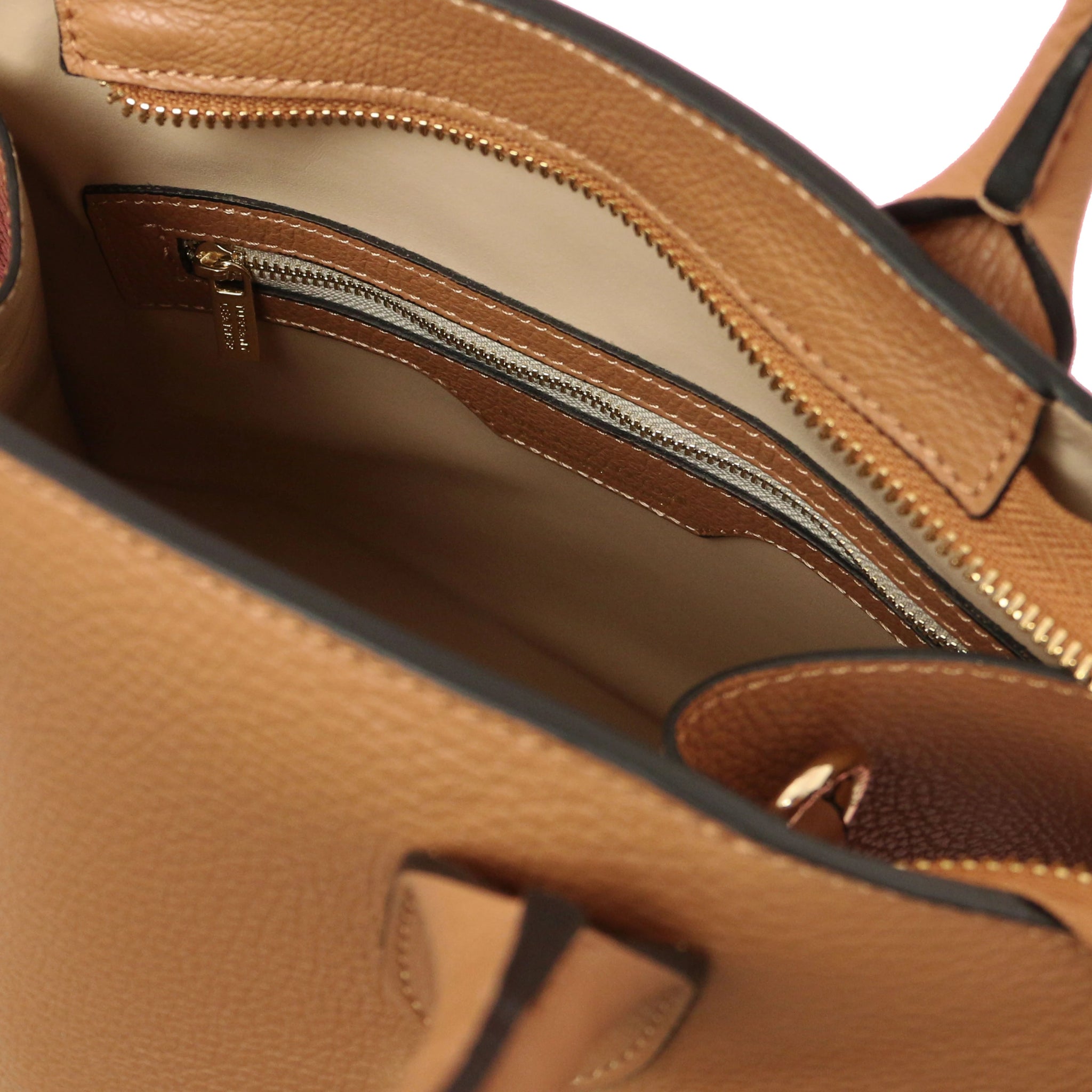 Interior Zip Pocket View Coccola Italian Pebbled Leather Handbag in Caramel with beige lining