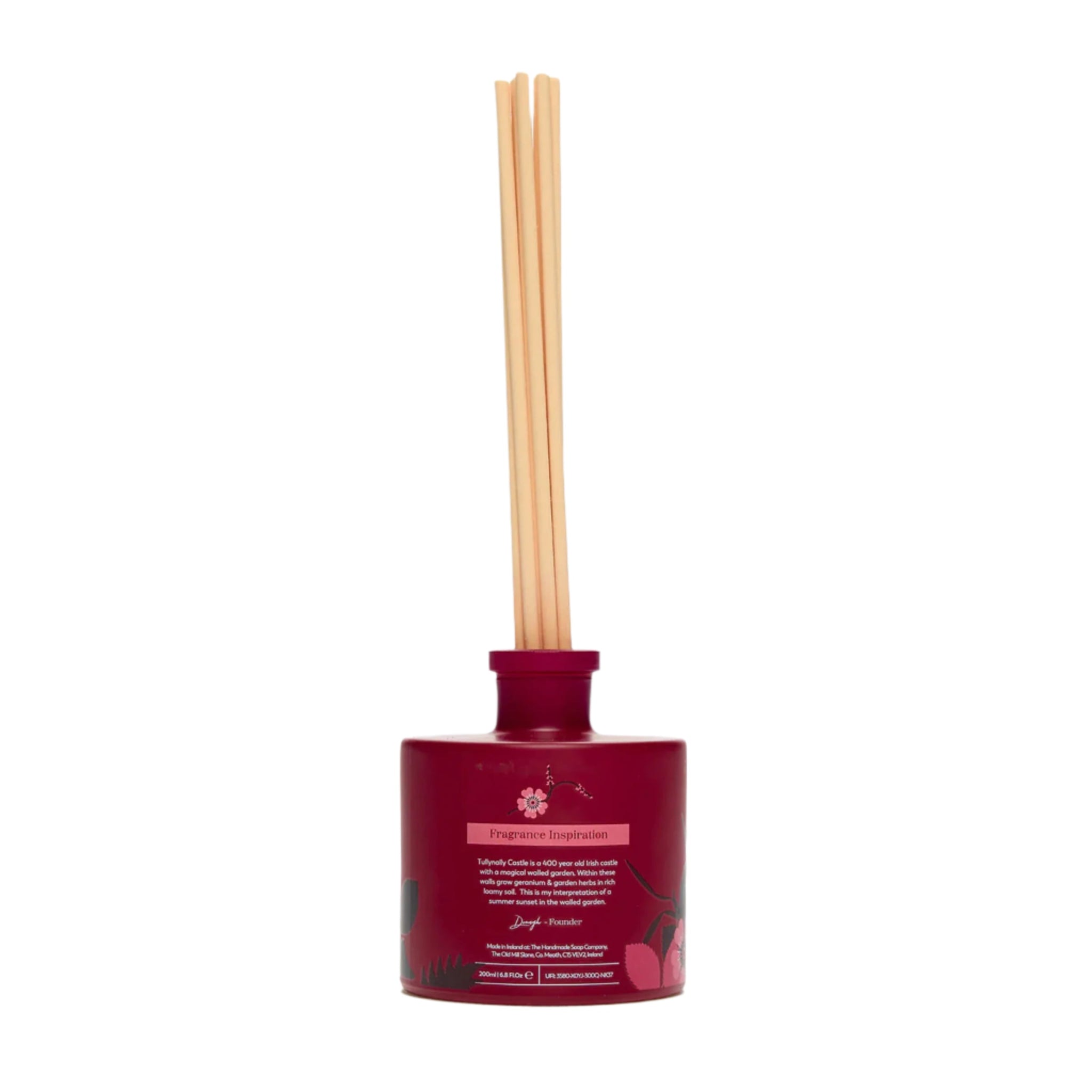 Red diffuser with wooden sticks on a white background