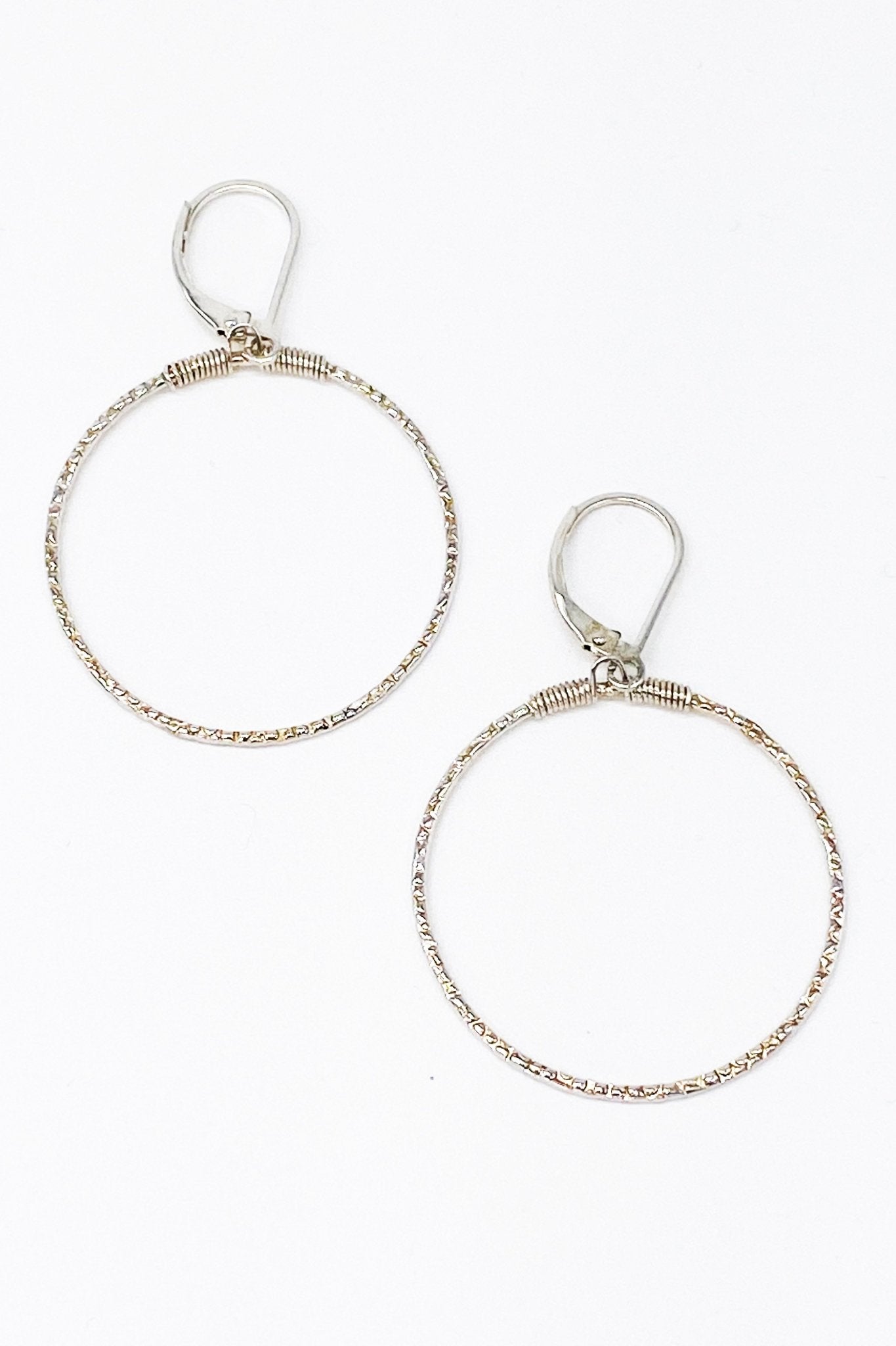 Dazzling Hammered Hoops in silver o a white background
