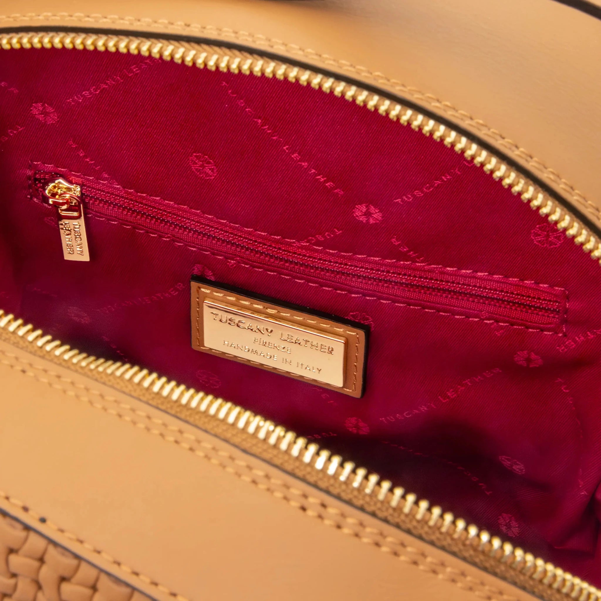 Interior zip pocket view Dedalo Leather Backpack in cognac with red lining