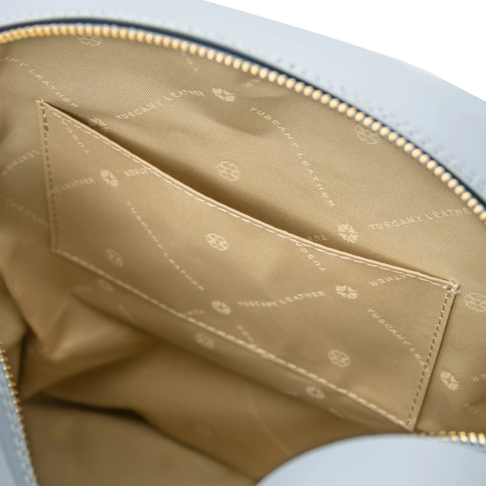 Interior open pocket view Dedalo Leather Backpack in light blue with beige lining