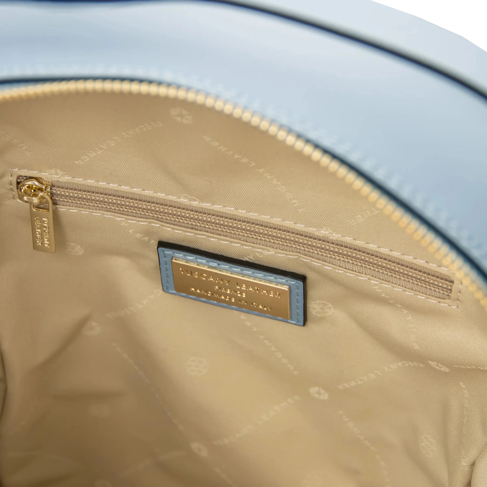 Interior zip pocket view Dedalo Leather Backpack in light blue with beige lining