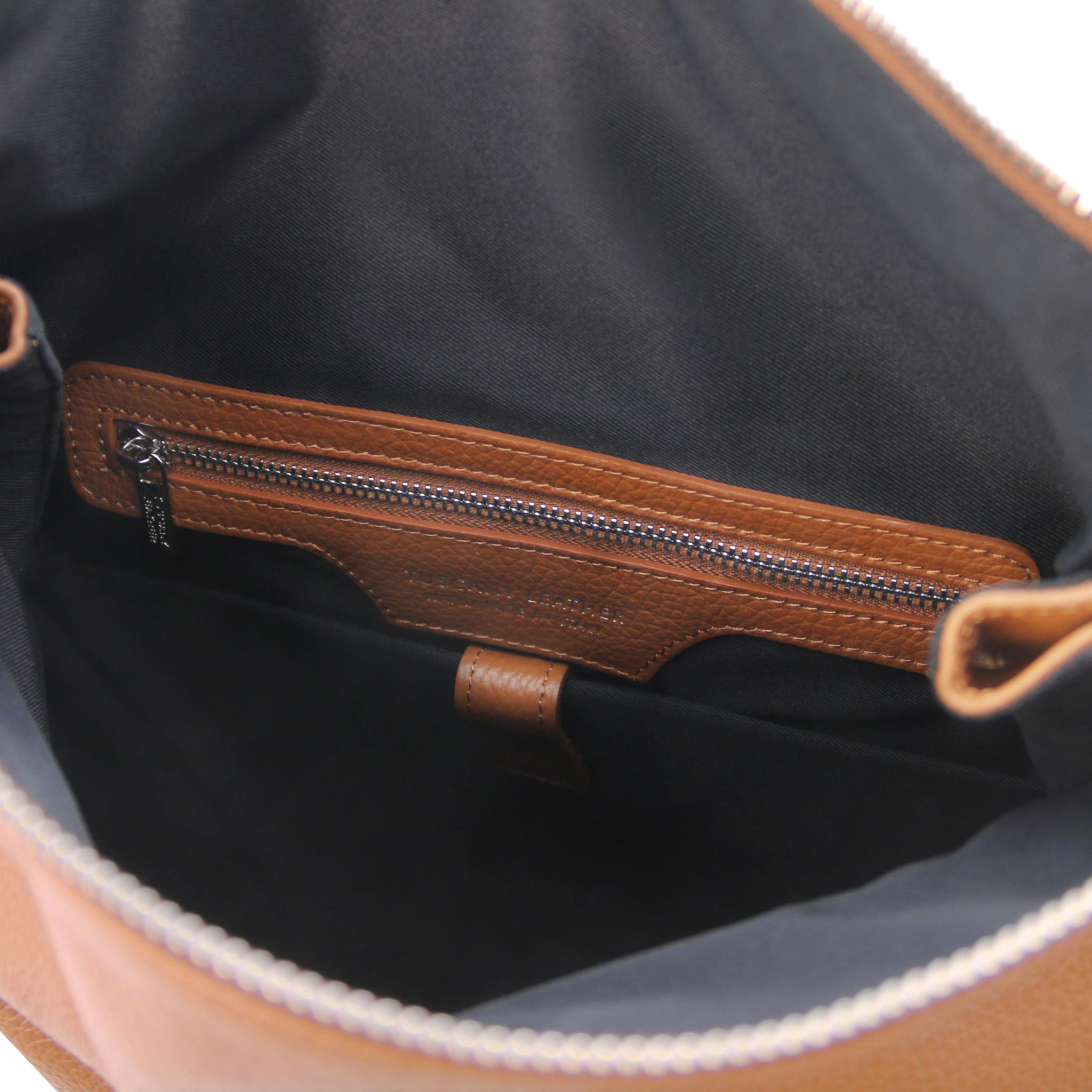 Interior view Denver Soft Italian Leather Backpack in Cognac showing black lining, cognac leather trim around zip pocket.