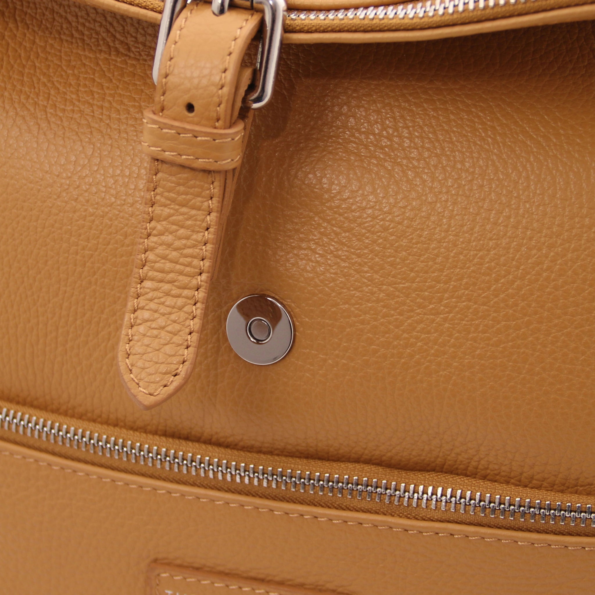 Magnetic front closure view Denver Soft Italian Leather Backpack in Caramel, featuring the buckle decorative strap