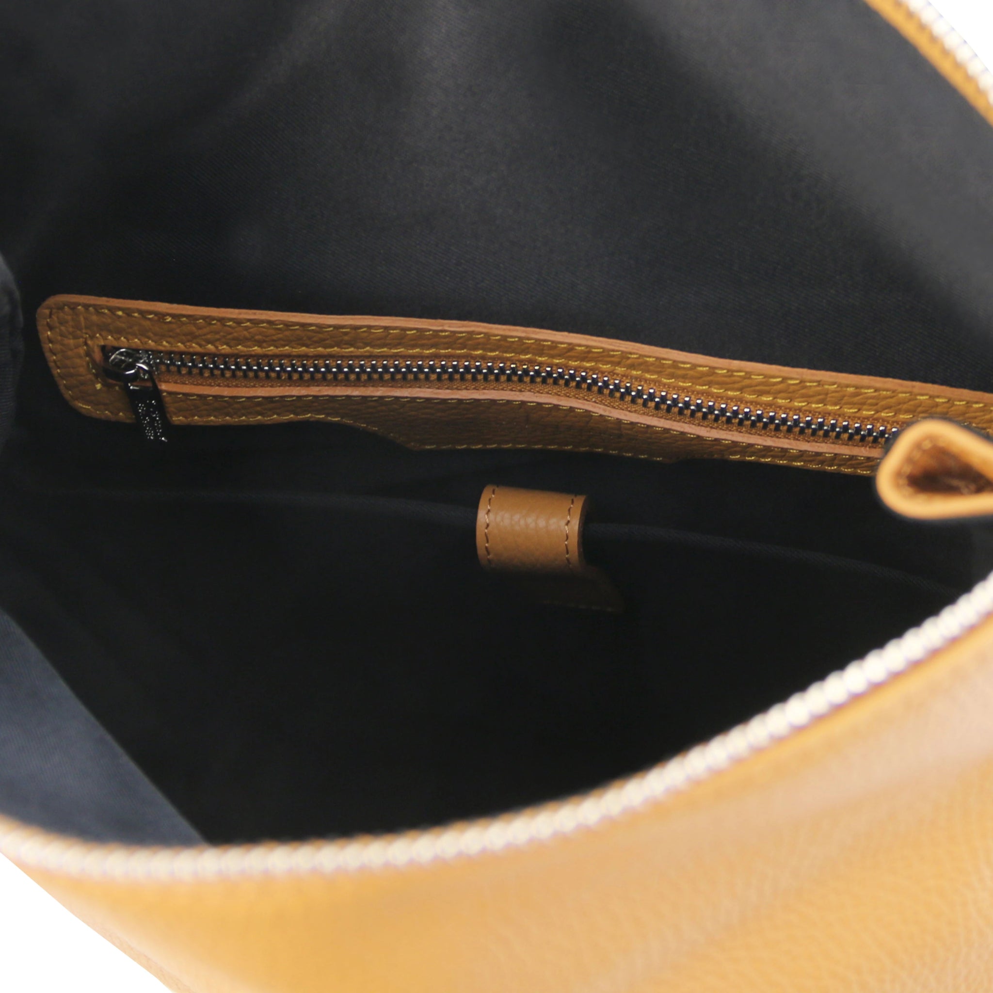 Interior view Denver Soft Italian Leather Backpack in Caramel showing black lining, caramel leather trim around zip pocket.