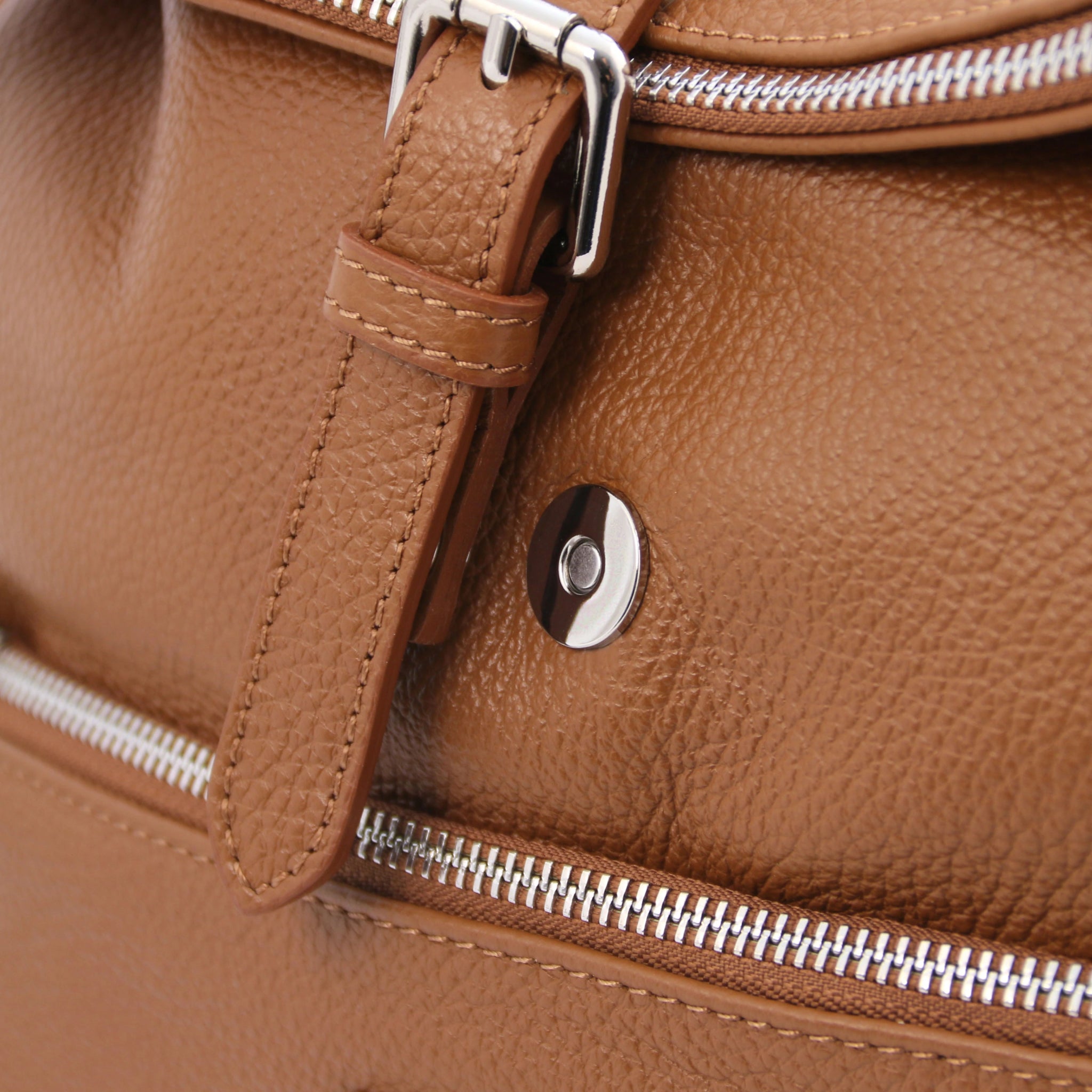 Magnetic front closure view Denver Soft Italian Leather Backpack in Cognac, featuring the buckle decorative strap
