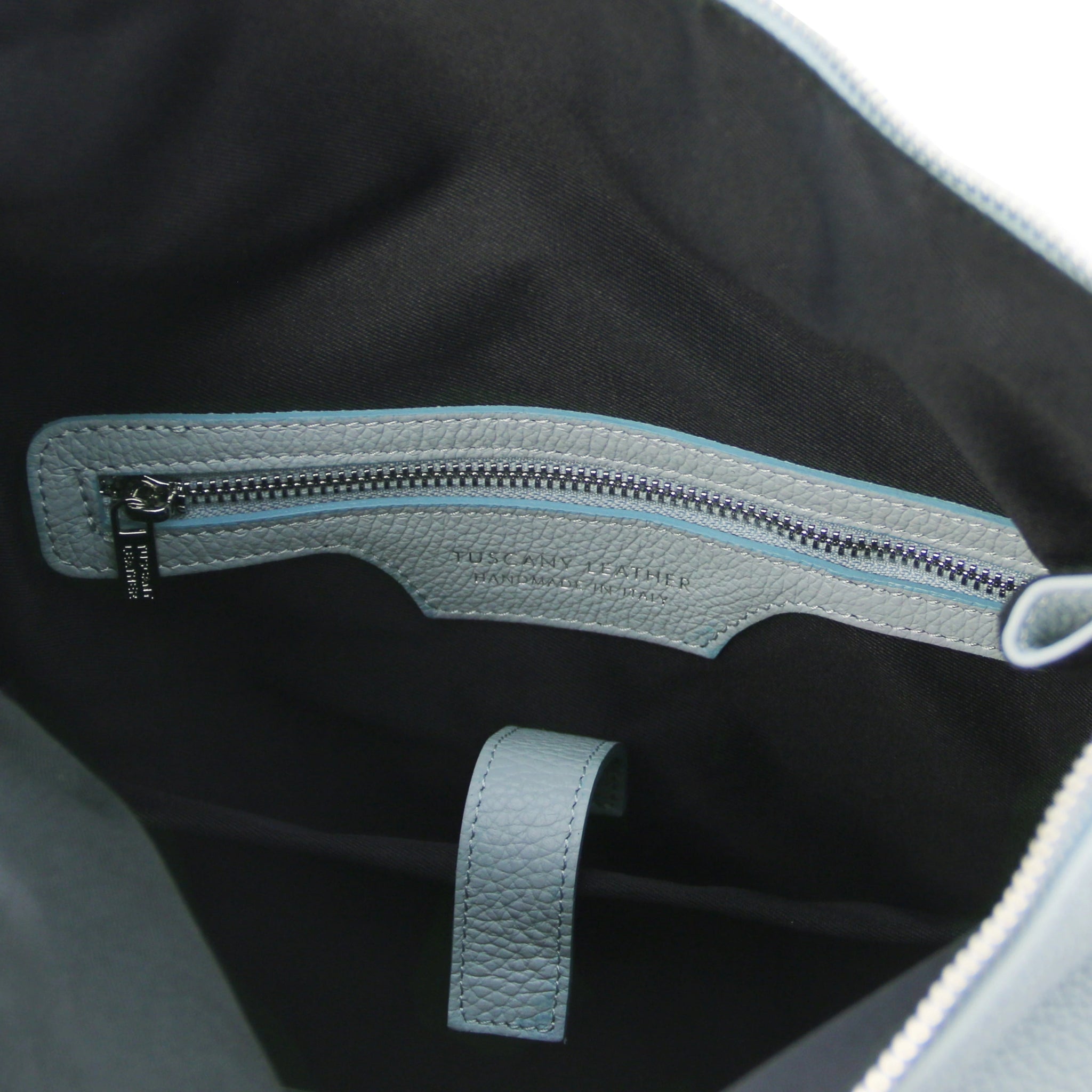 Interior view Denver Soft Italian Leather Backpack in  Light Blue, featuring black fabric lining, blue leather trim around the zippered pocket.