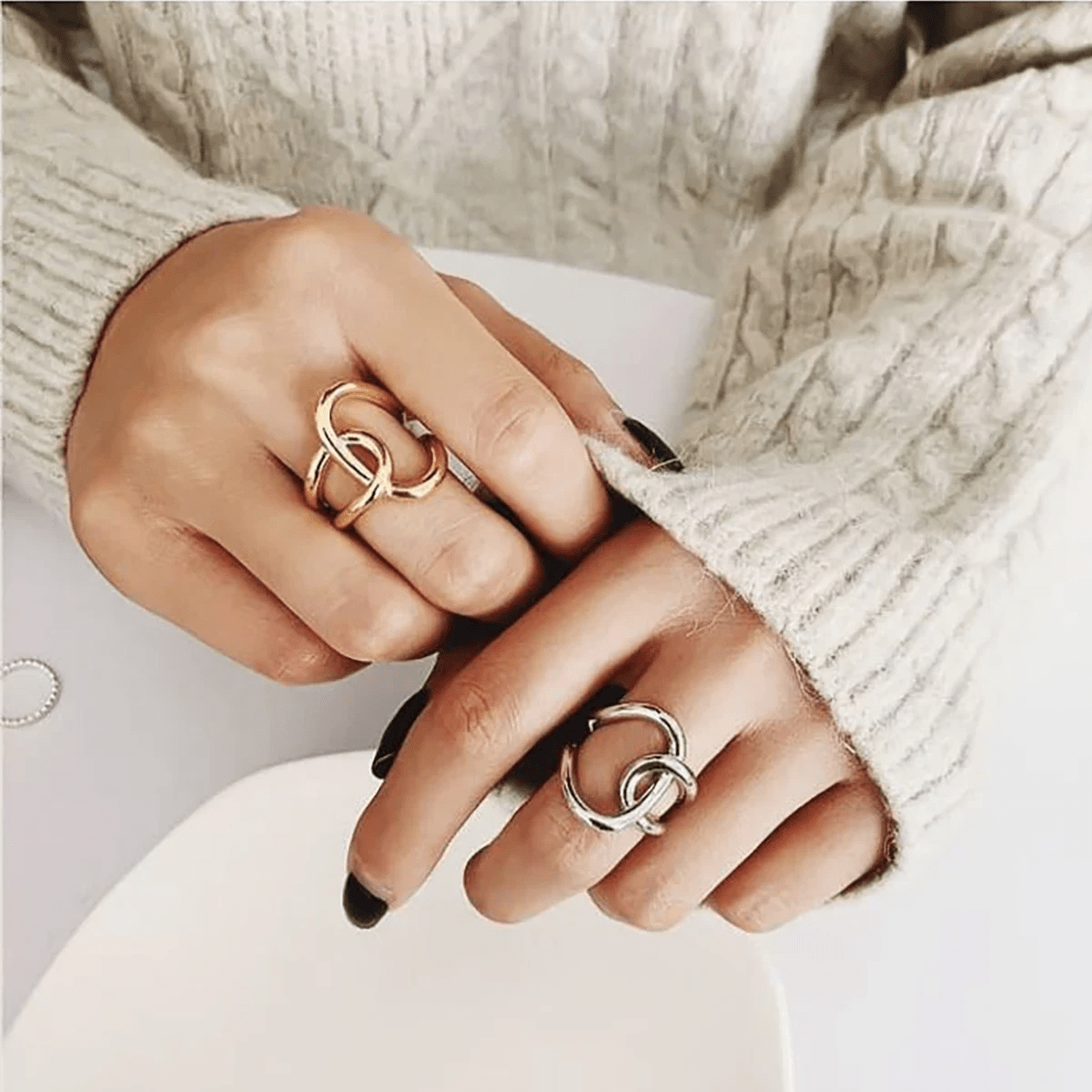 Close up view Downtown Golden Ring on both of a women's middle fingers