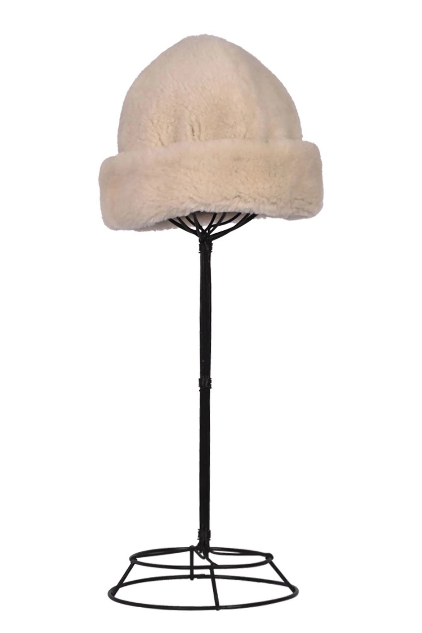 English Sheepskin Pull On Beanie in Cream on a hat stand in front of a white background