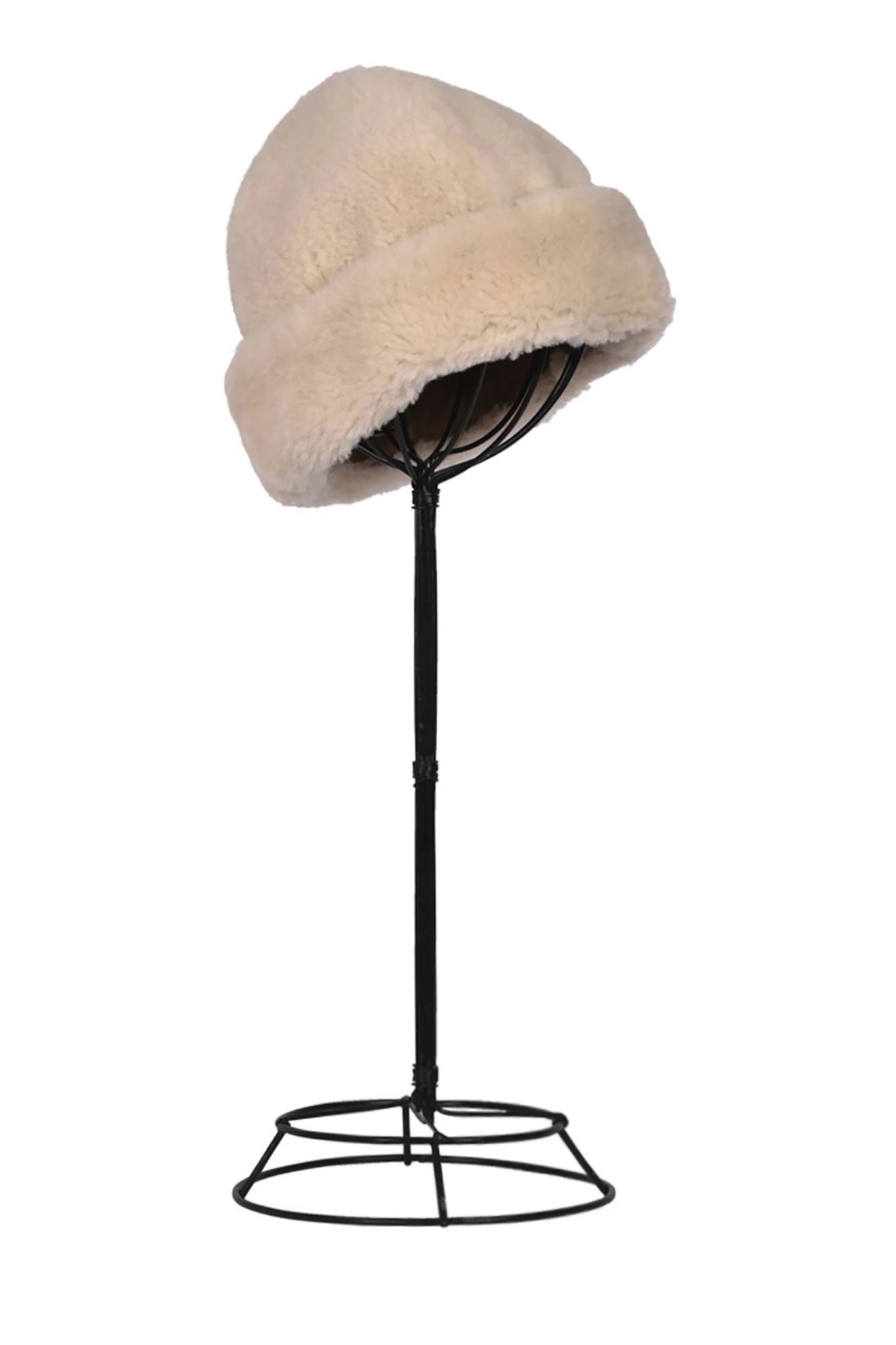 English Sheepskin Pull On Beanie in Cream on a black hat stand