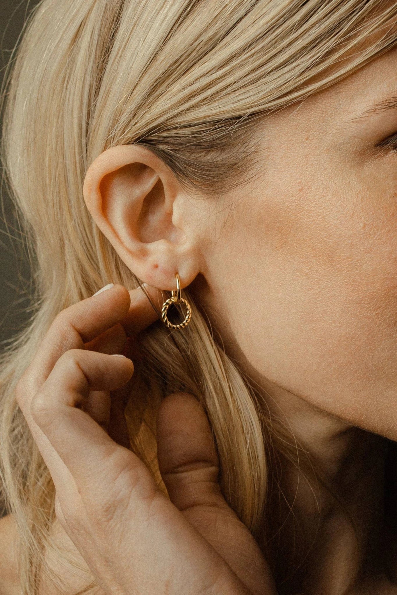 Gold Vermeil Circle Dangle Earring on a woman's right ear