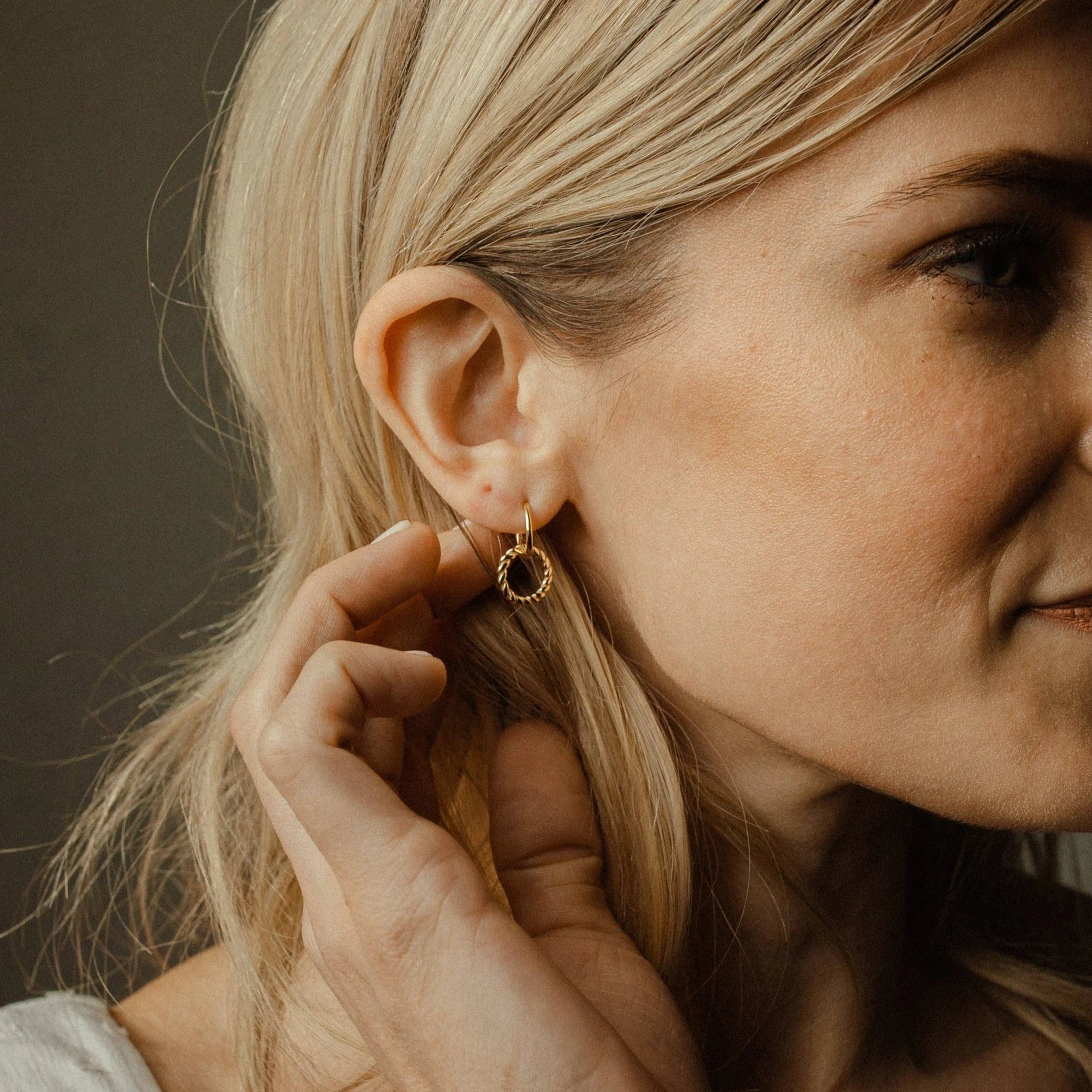 Gold Vermeil Circle Dangle Earring on a woman's right ear
