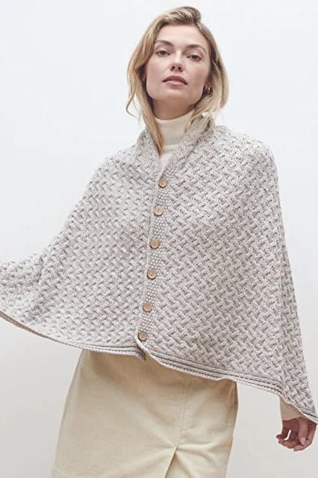 A female model wearing the Irish Clew Bay Supersoft Convertible Cape in oatmeal as a true cape