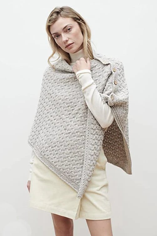 A female model wearing the Irish Clew Bay Supersoft Convertible Cape in oatmeal as a poncho