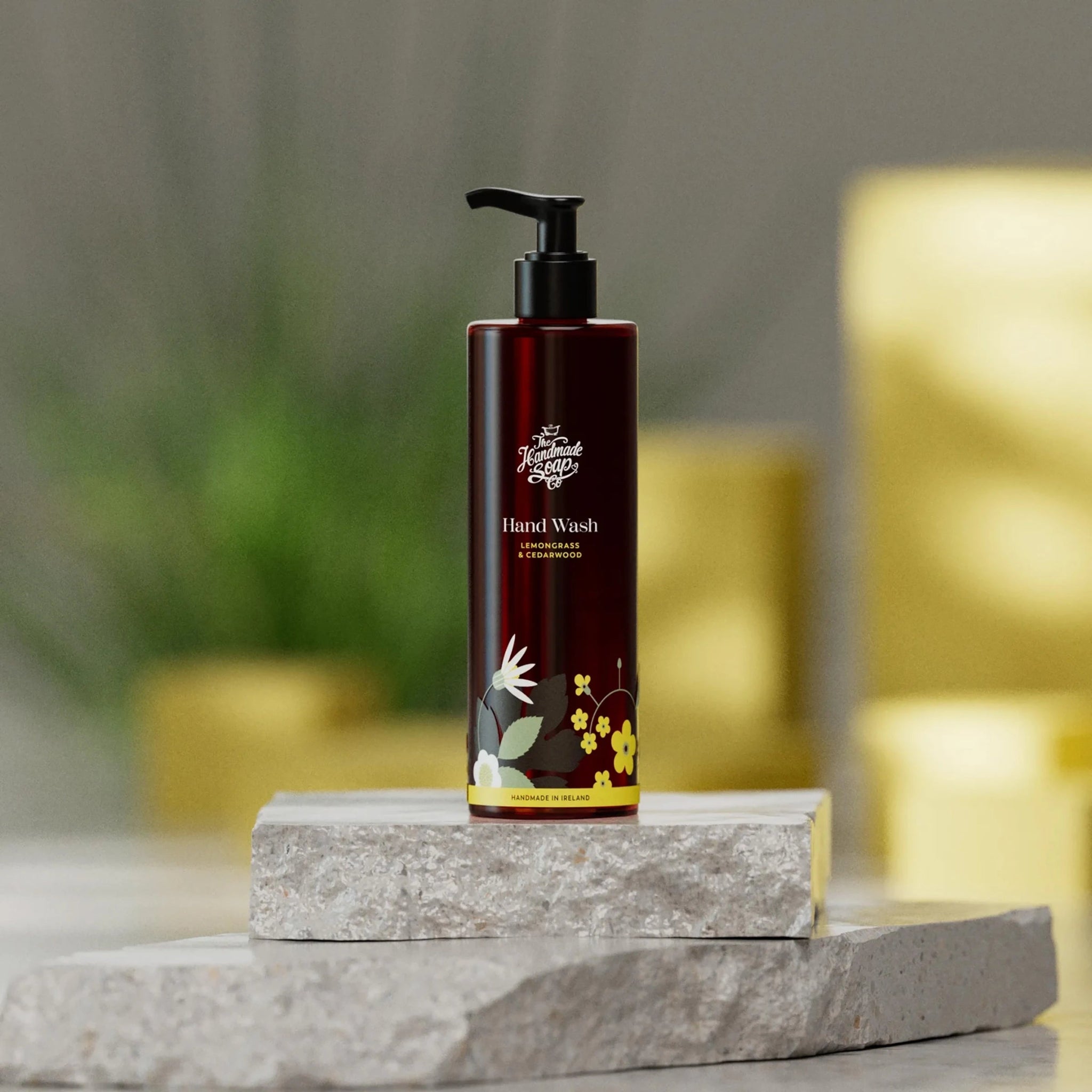 Hand wash bottle with floral design on a stone surface